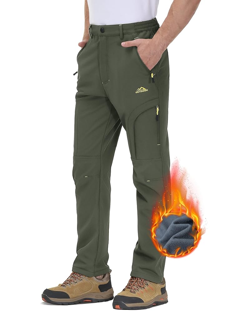 Winter hiking pants being field tested in snowy mountainous terrain with hiking boots and gaiters