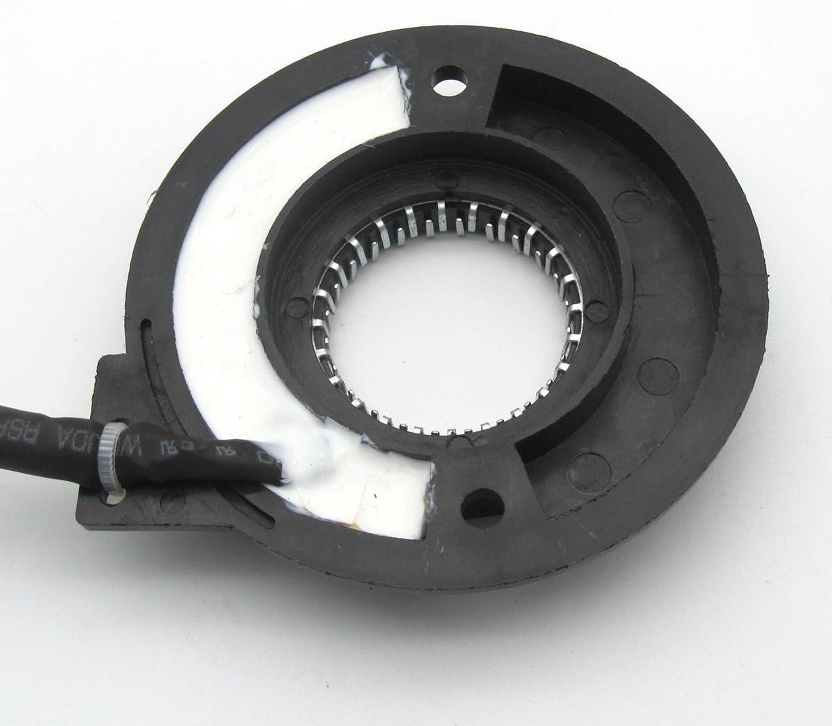 A baix view of the ckpsms KUNPENG #110-32562 Dynamo Stator, showing the internal wiring and a white sealant.