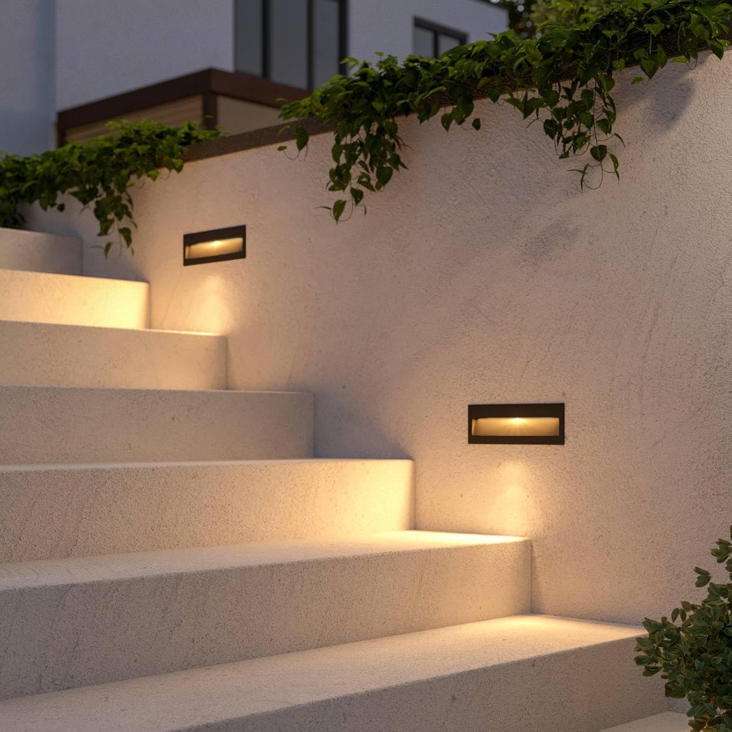 Two Lucande Loya LED wall lights installed on an outdoor staircase, providing ambient lighting for the steps.