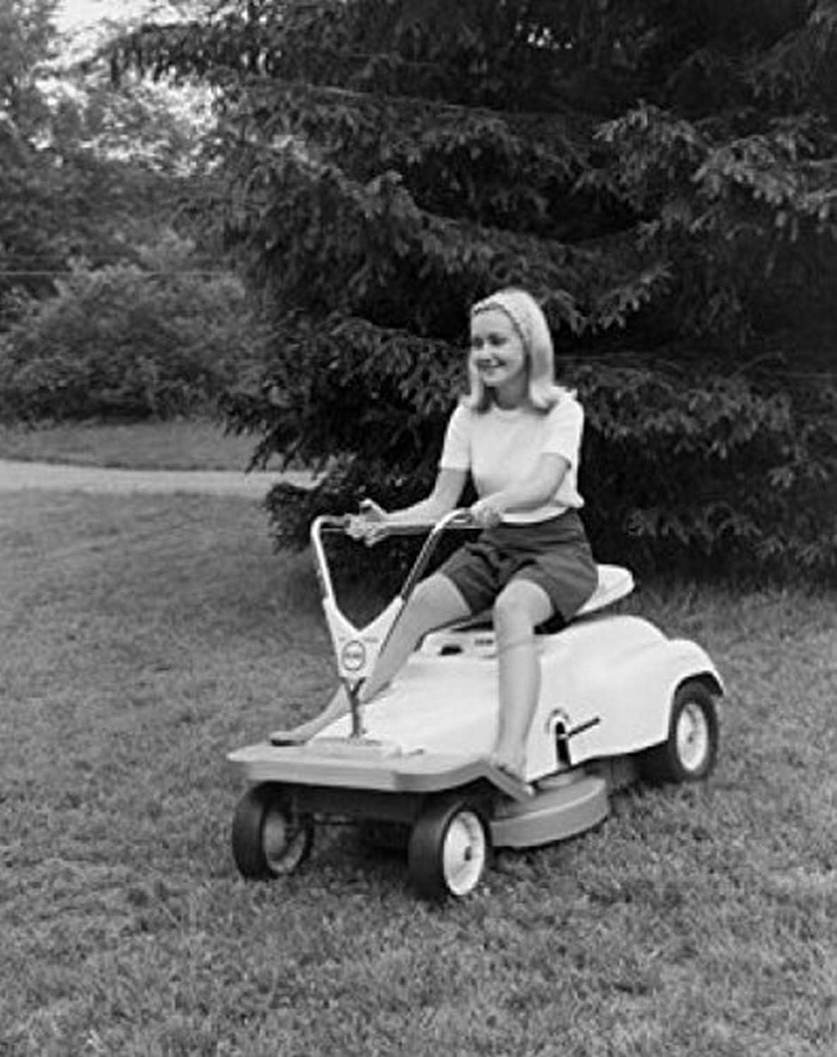 Posterazzi Young woman riding a lawn mower Poster Print product image