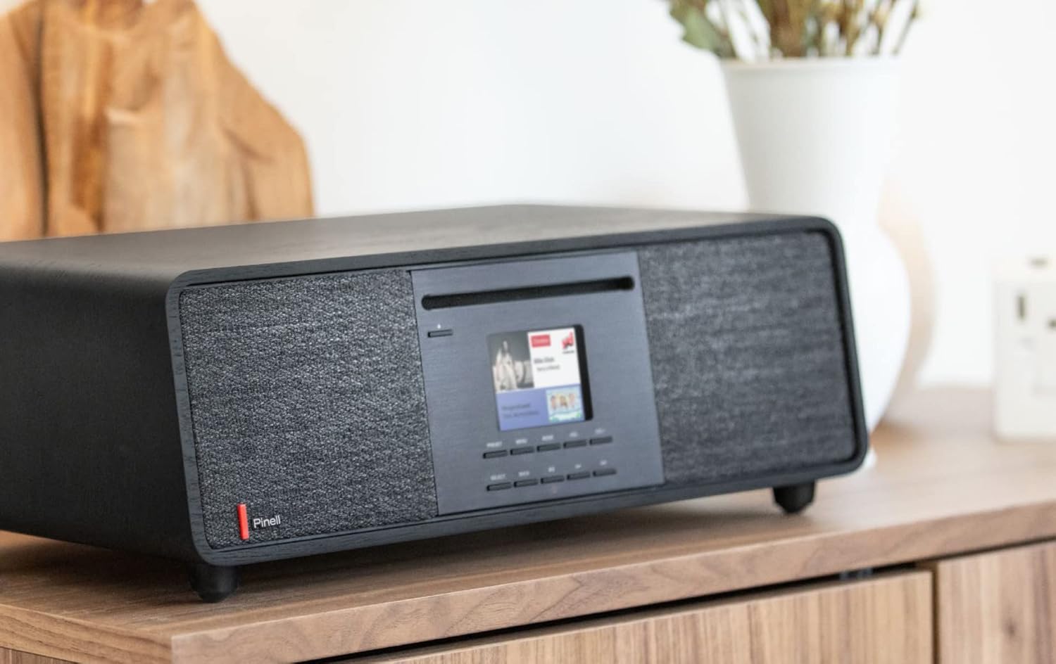 Pinell Supersound 701 radio from a side angle on a wooden surface