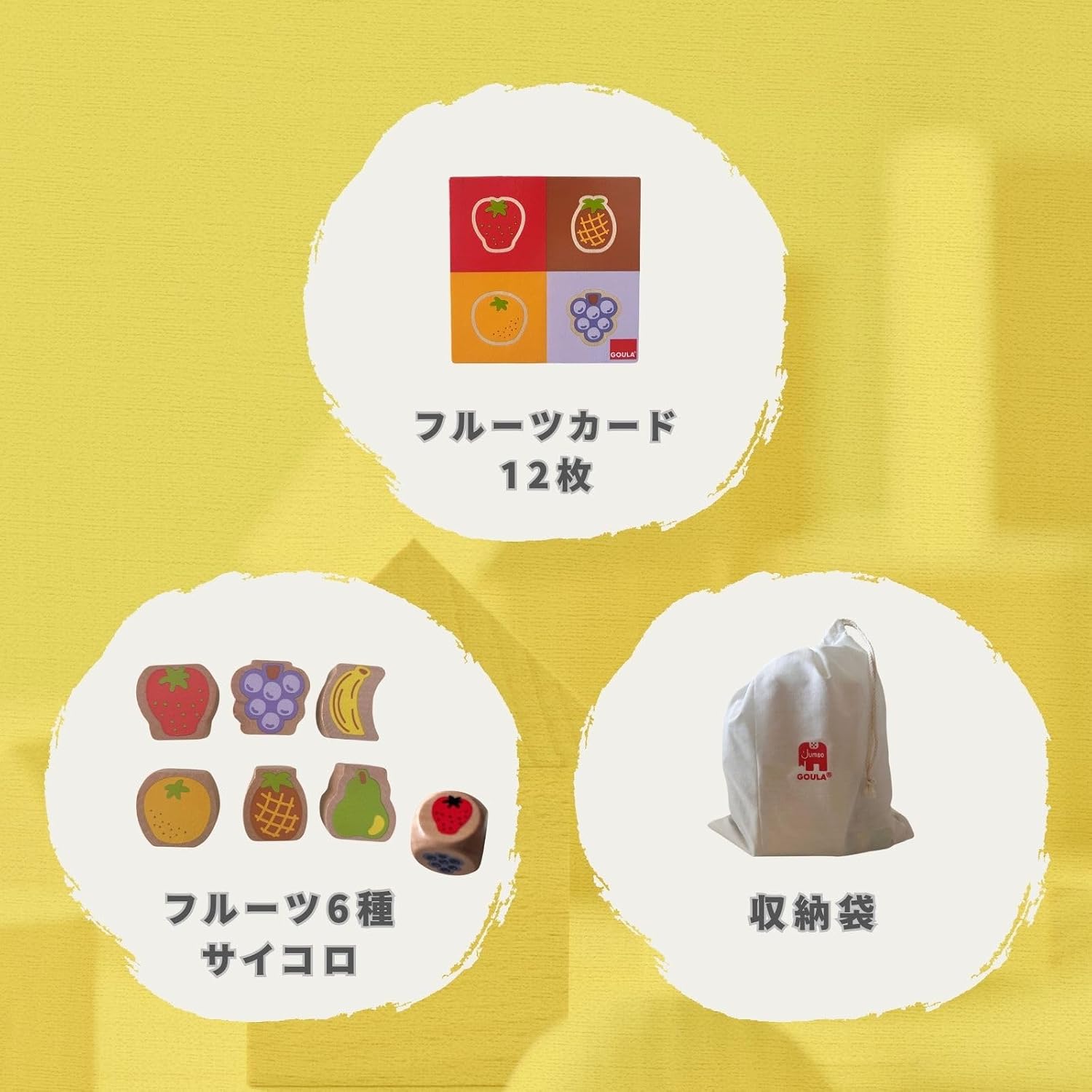 A child playing the GOULA Fruit Tower game, rolling the dice and carefully placing a wooden fruit piece onto the tower.