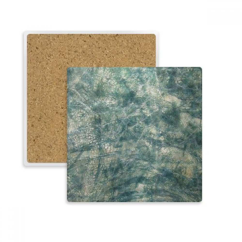 Dessous de verre absorbant motif cuir noir pour protéger la table basse du salon