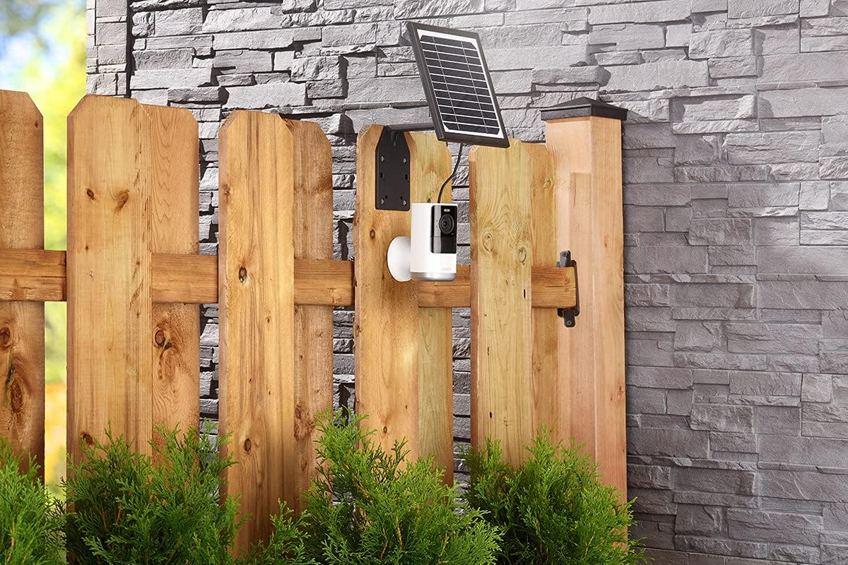 Solar panel and camera mounted on a wooden fence