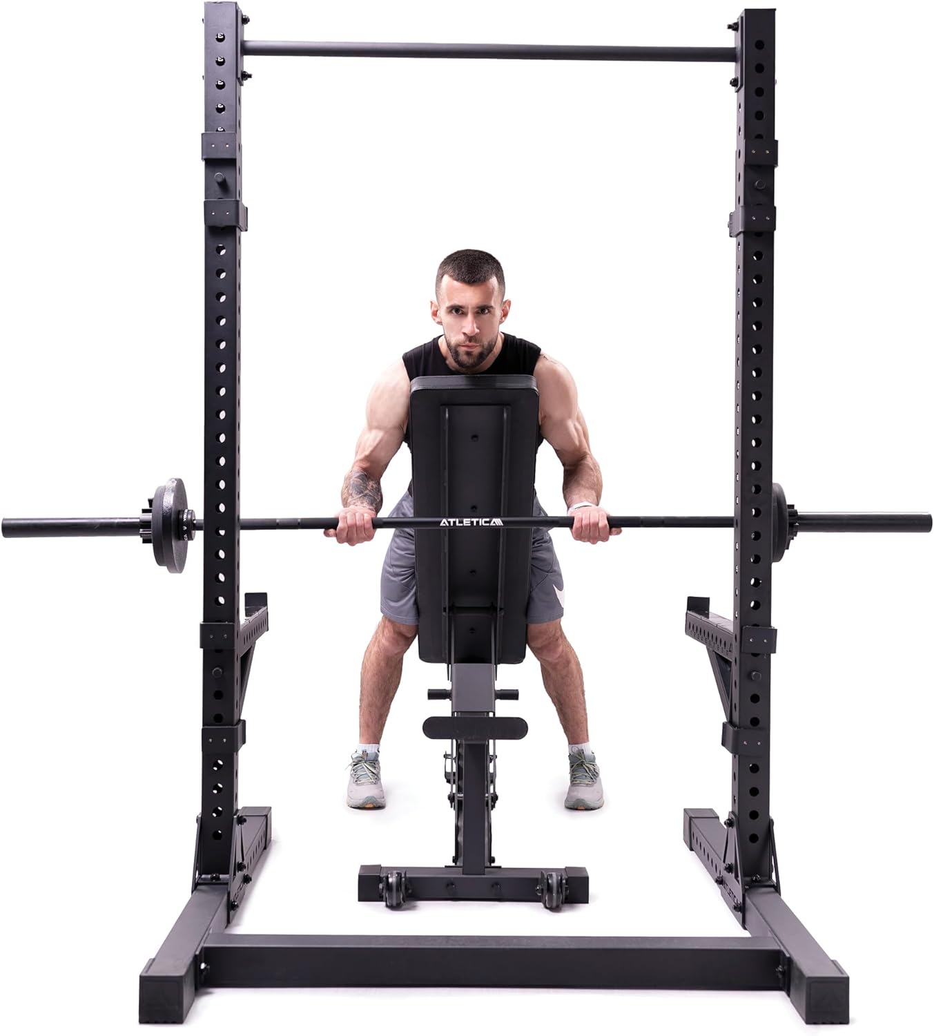 Man performing bent-over rows inside ATLETICA R7 Squat Rack