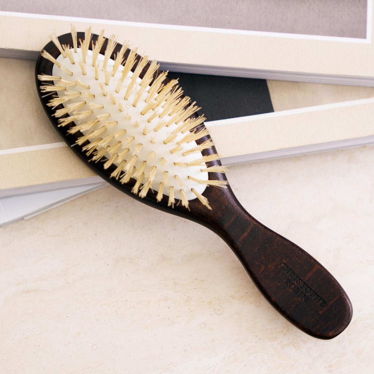 Christophe Robin Natural Boar-Bristle Travel Hairbrush | Travel boar-bristle brush that gently detangles, smooths and boosts shine for all hair types.