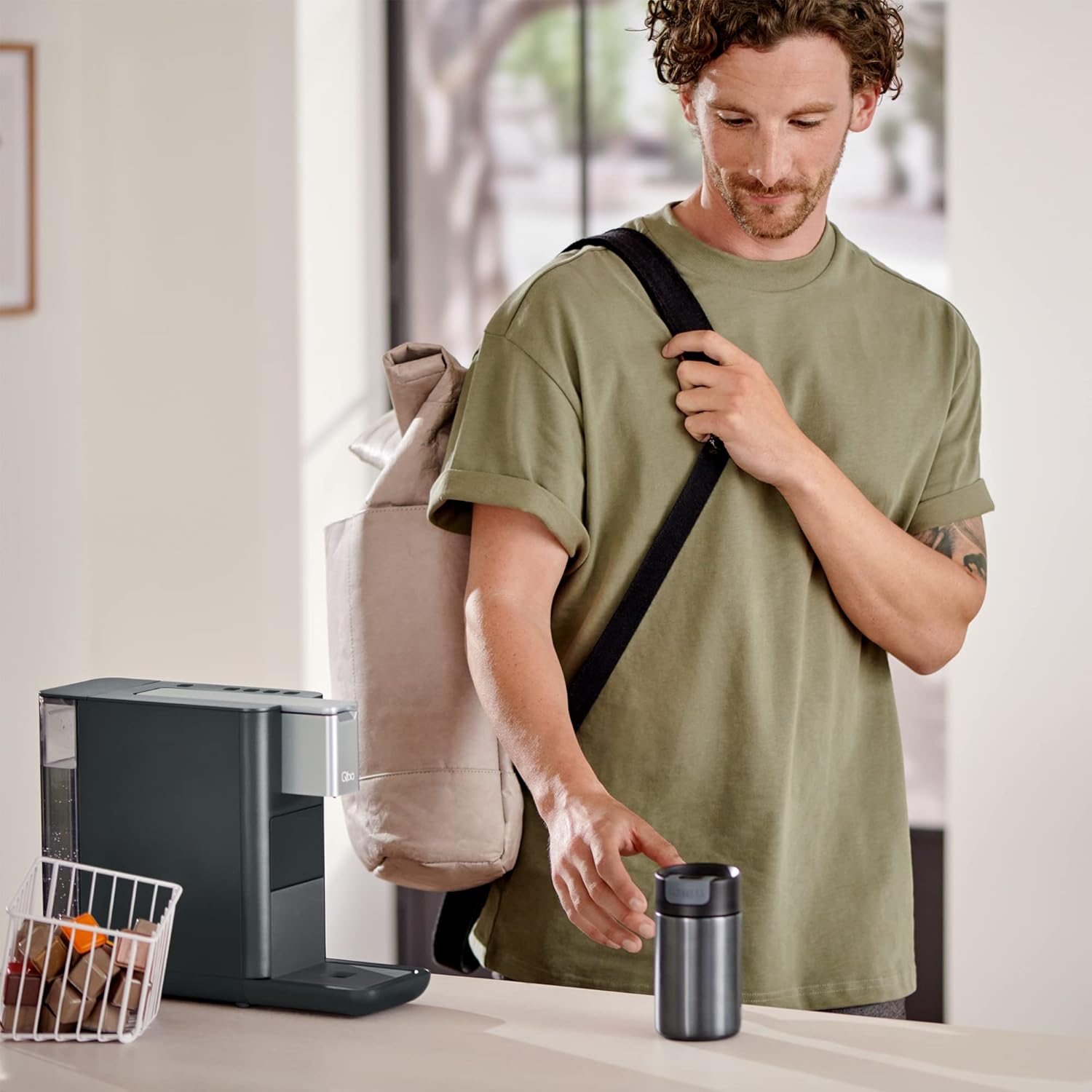 Person using Tchibo Qbo Essential Premium Capsule Machine