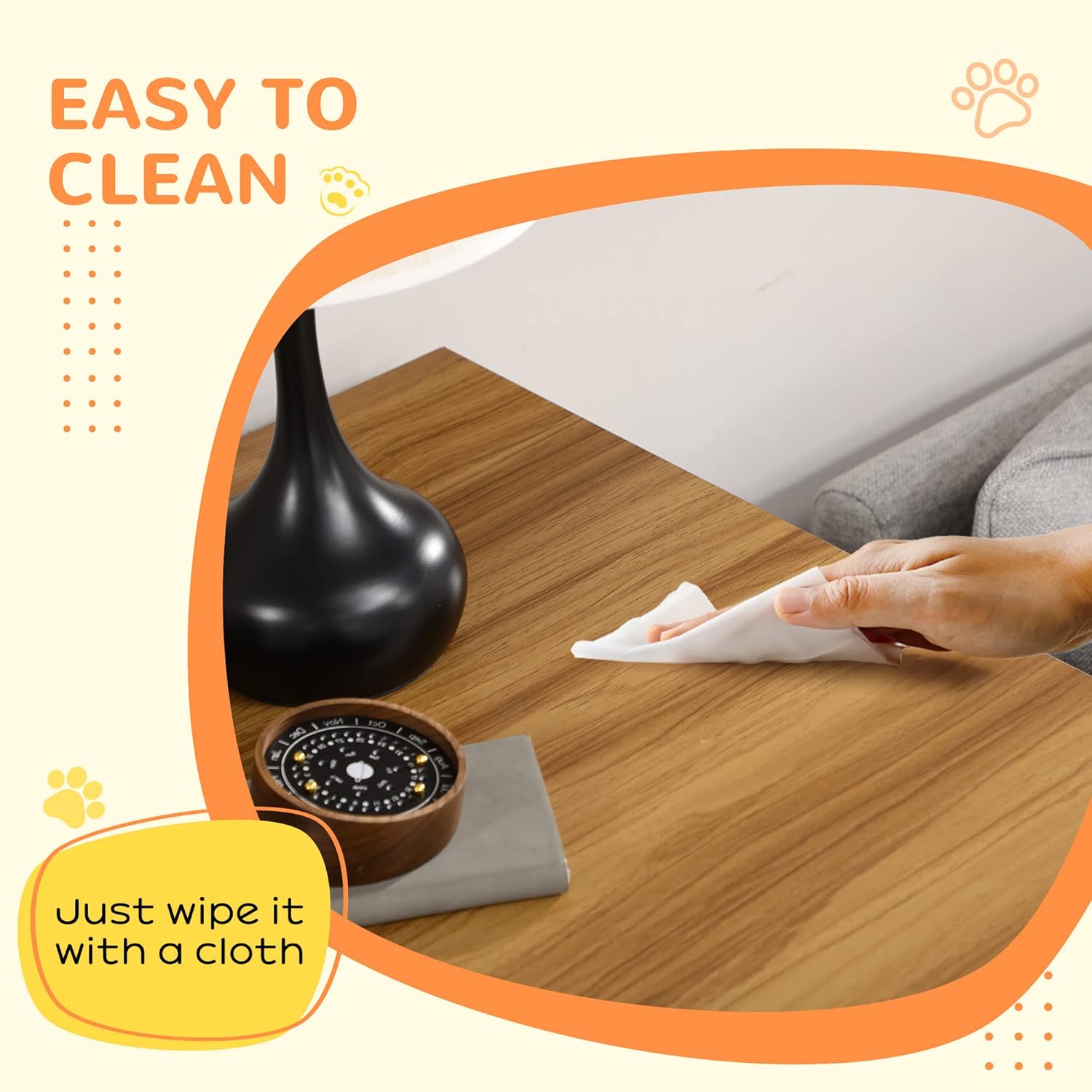 A hand wiping the surface of the dog crate furniture with a cloth, demonstrating easy cleaning.
