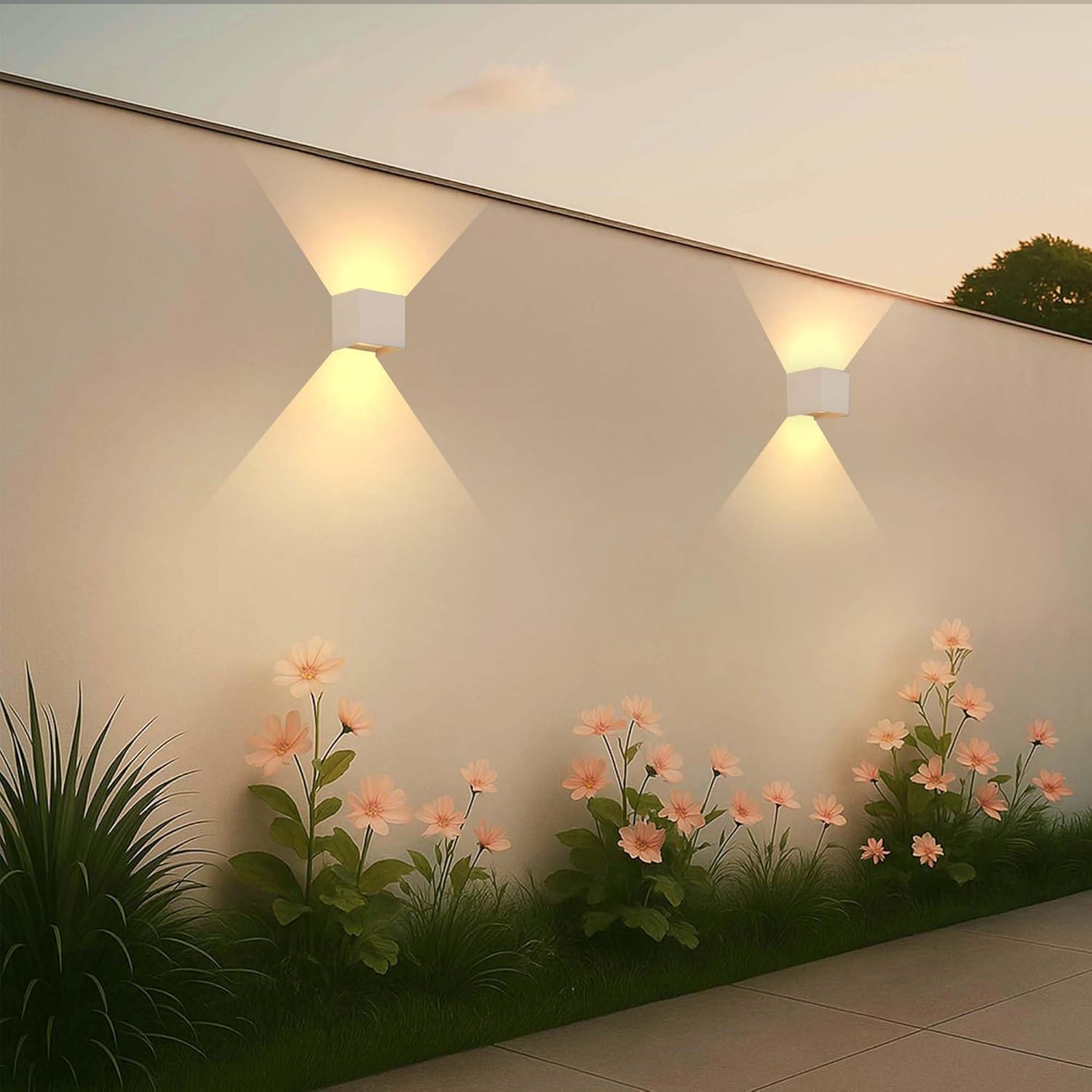 Two Ledvion wall lamps installed on an outdoor wall with flowers