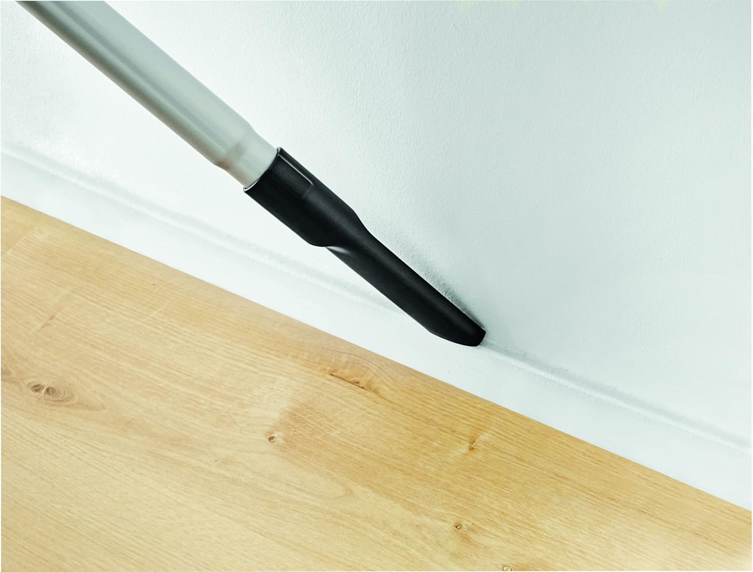 Upholstery nozzle cleaning a sofa