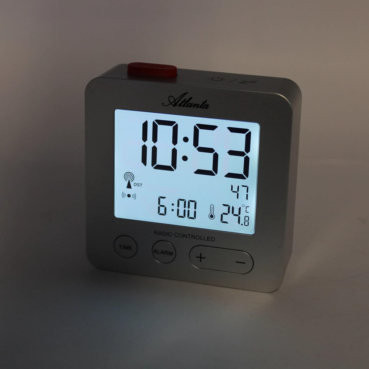 Depan view of the Atlanta 1882-19 Digital LCD Alarm Clock with its blue backlight activated, showing clear time, date, and temperature.