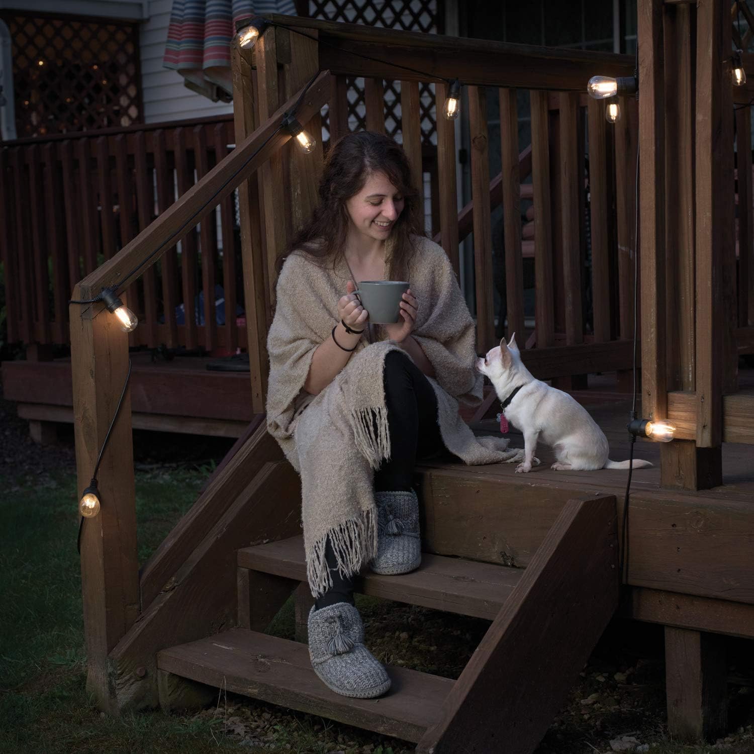 String lights installed on a wooden deck railing