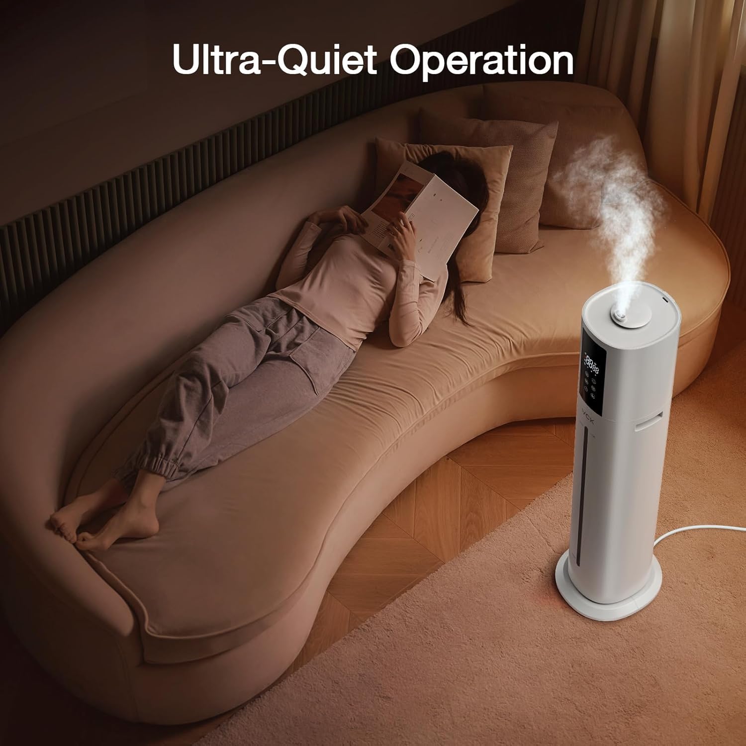 VCK Humidifier operating quietly in a bedroom while a person reads in bed.