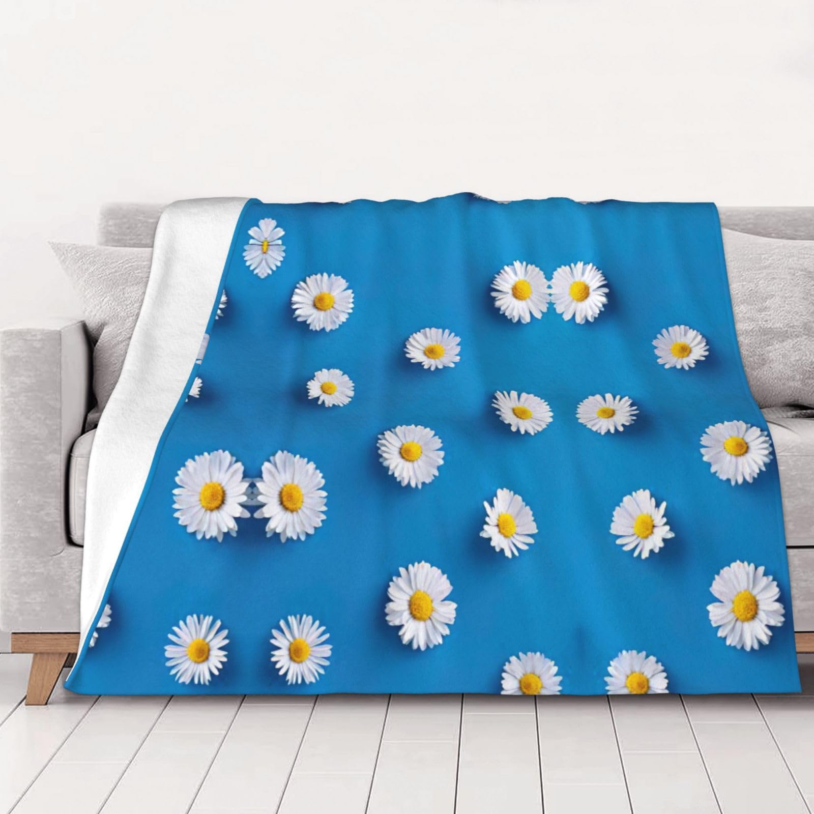 Couverture flanelle marguerites douceur et réconfort pour des moments uniques en salon