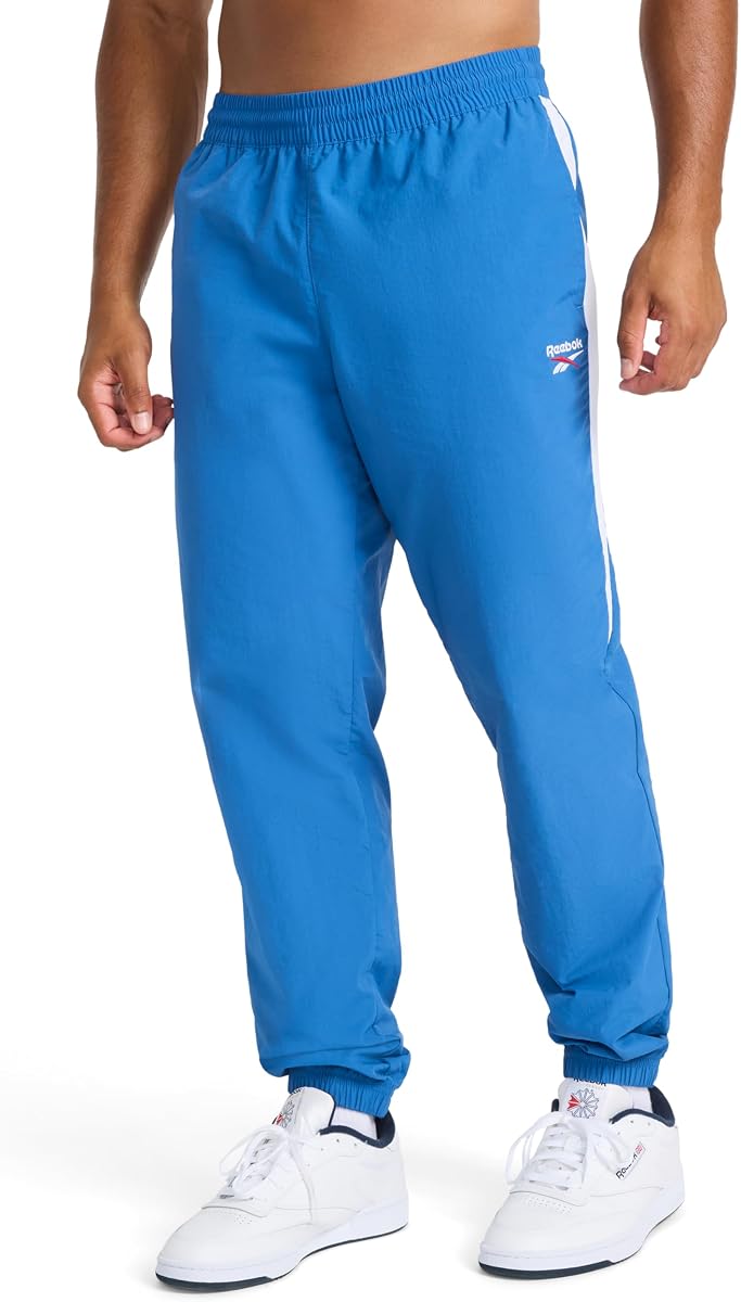 Reebok Pantalón tejido Cross Check para hombre, ajuste estándar, tejido de nailon ligero