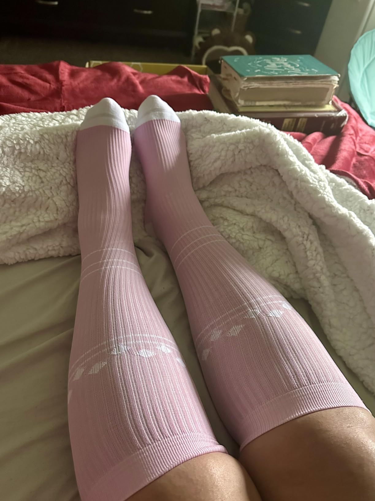 Green, pink, and purple Solunara compression socks