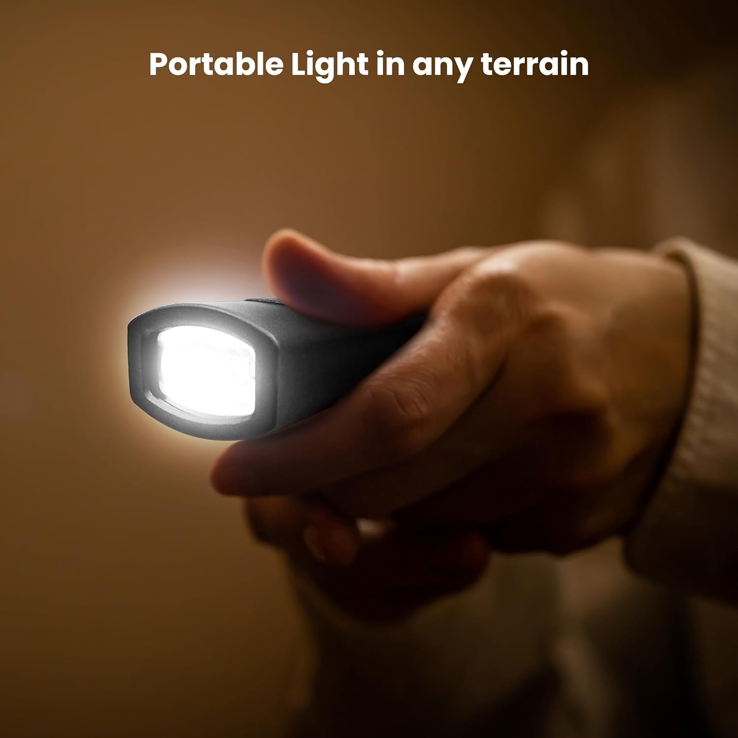 Hand holding a detached flashlight from the Feit Electric LANRFL1000 LED Lantern