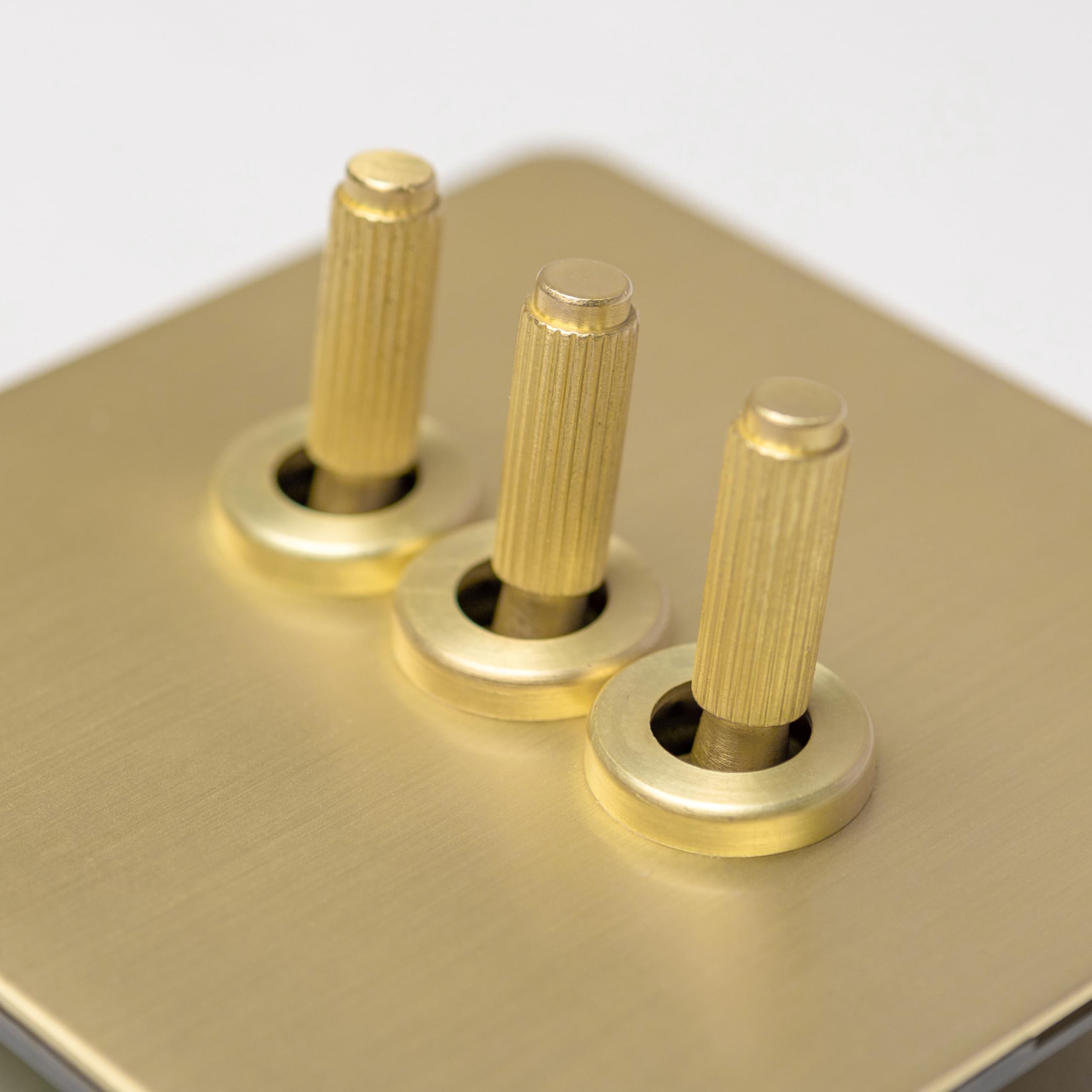 Satin Brass Straight Knurled Switches and Sockets (3 gang 2 way Toggle) — image 1