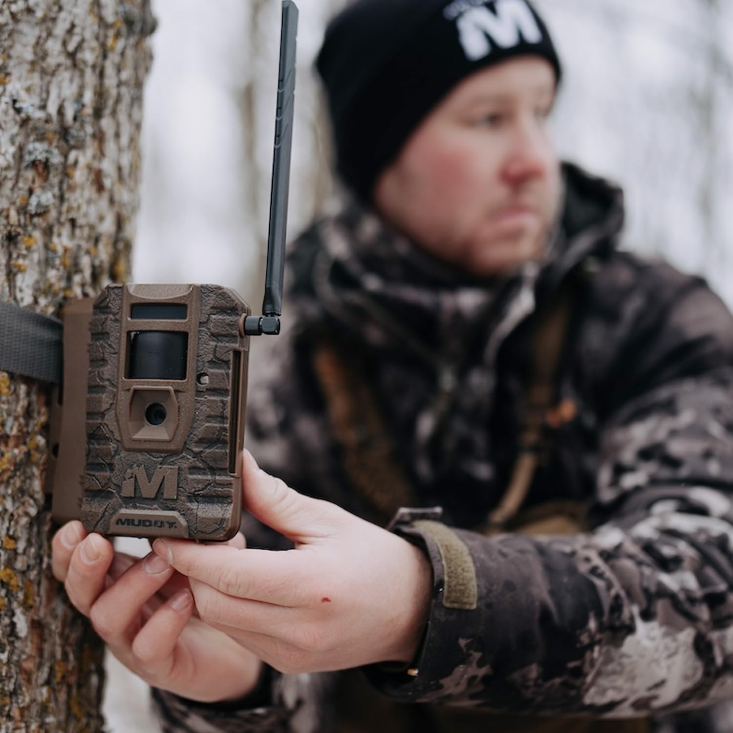 Person holding MUDDY Mitigator 2.0 camera with antenna