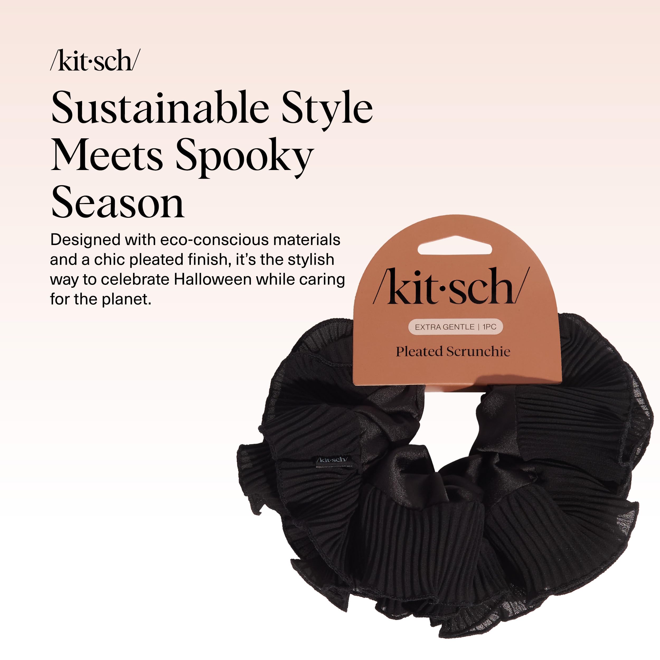 Close-up of the Kitsch black pleated scrunchie, highlighting its fabric texture and pleated design.