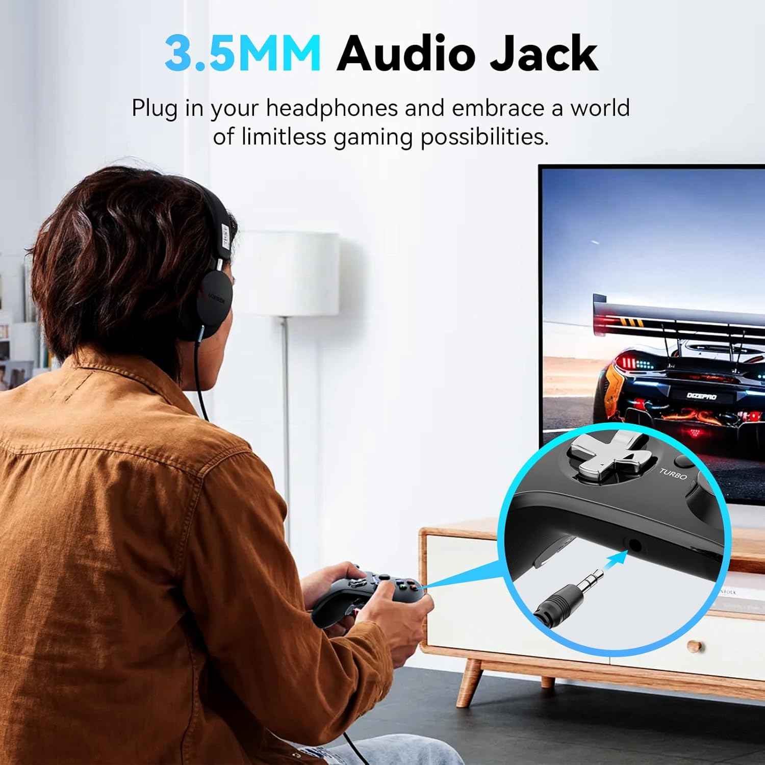 Person playing a game with the RALAN controller, plugging a 3.5mm headphone jack into the controller