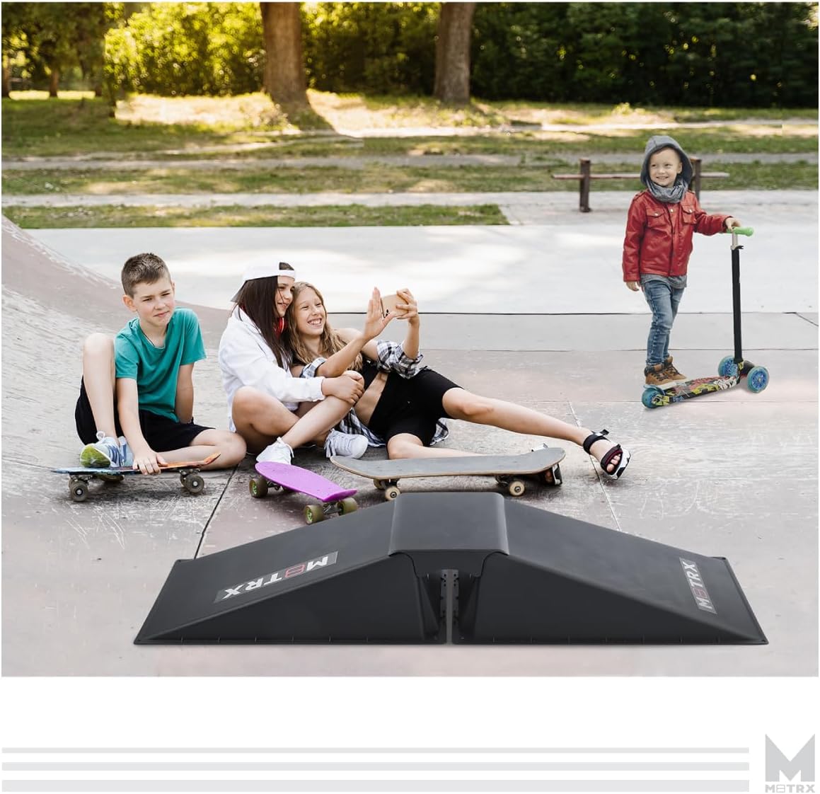 Children gathered around the M8TRX 2in1 Skateboard Ramp in a skate park setting.