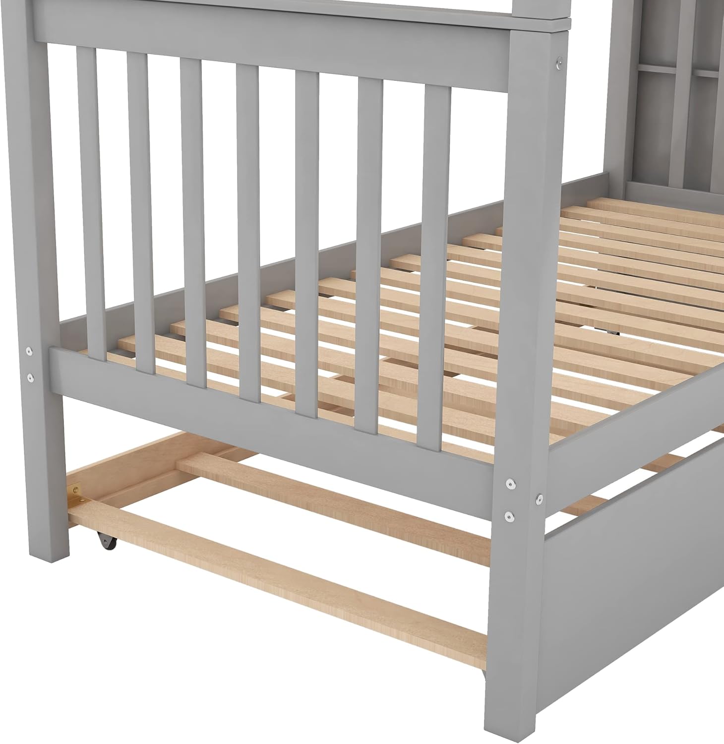 Close-up view of the trundle bed's wheels and wooden slats, showing its mobility and construction.