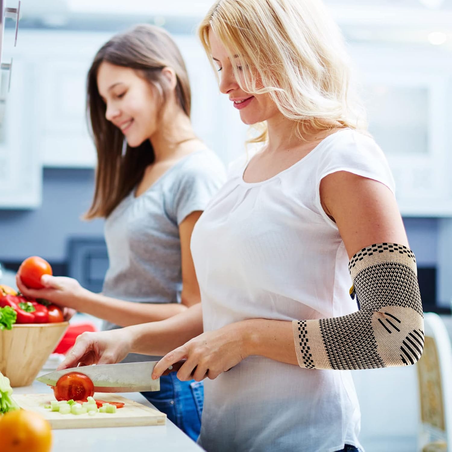 A woman wearing an ABYON elbow compression sleeve while preparing food in a kitchen, demonstrating active use.