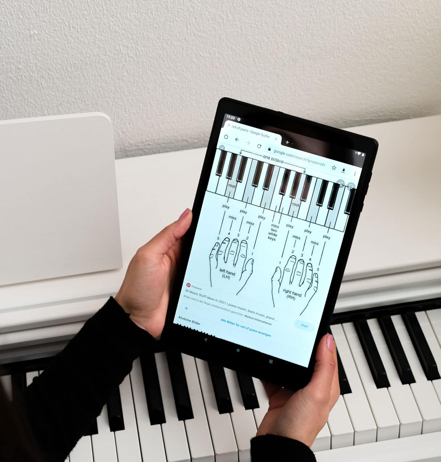 Person viewing piano sheet music or tutorial on the Jay-tech G10.11 Tablet PC.