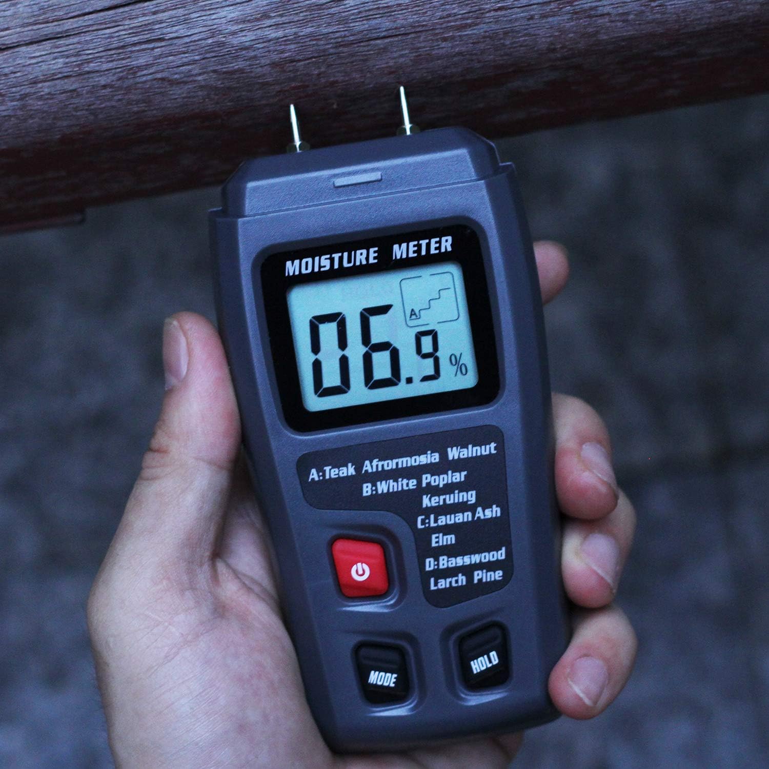 Hand holding Bside EMT01 Digital Wood Moisture Meter, showing its compact size