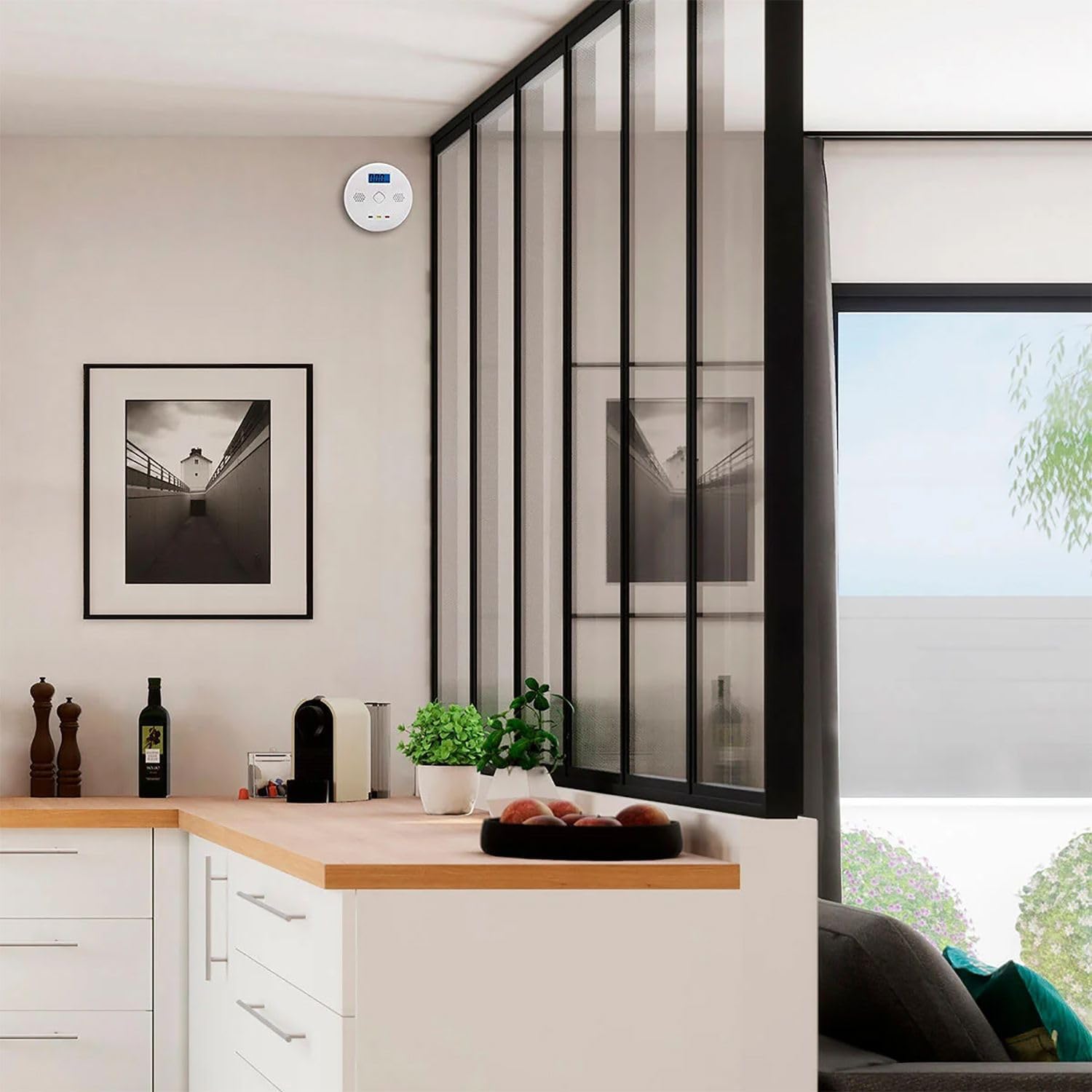 GBC iSnatch Carbon Monoxide Detector mounted on a wall in a modern kitchen setting.