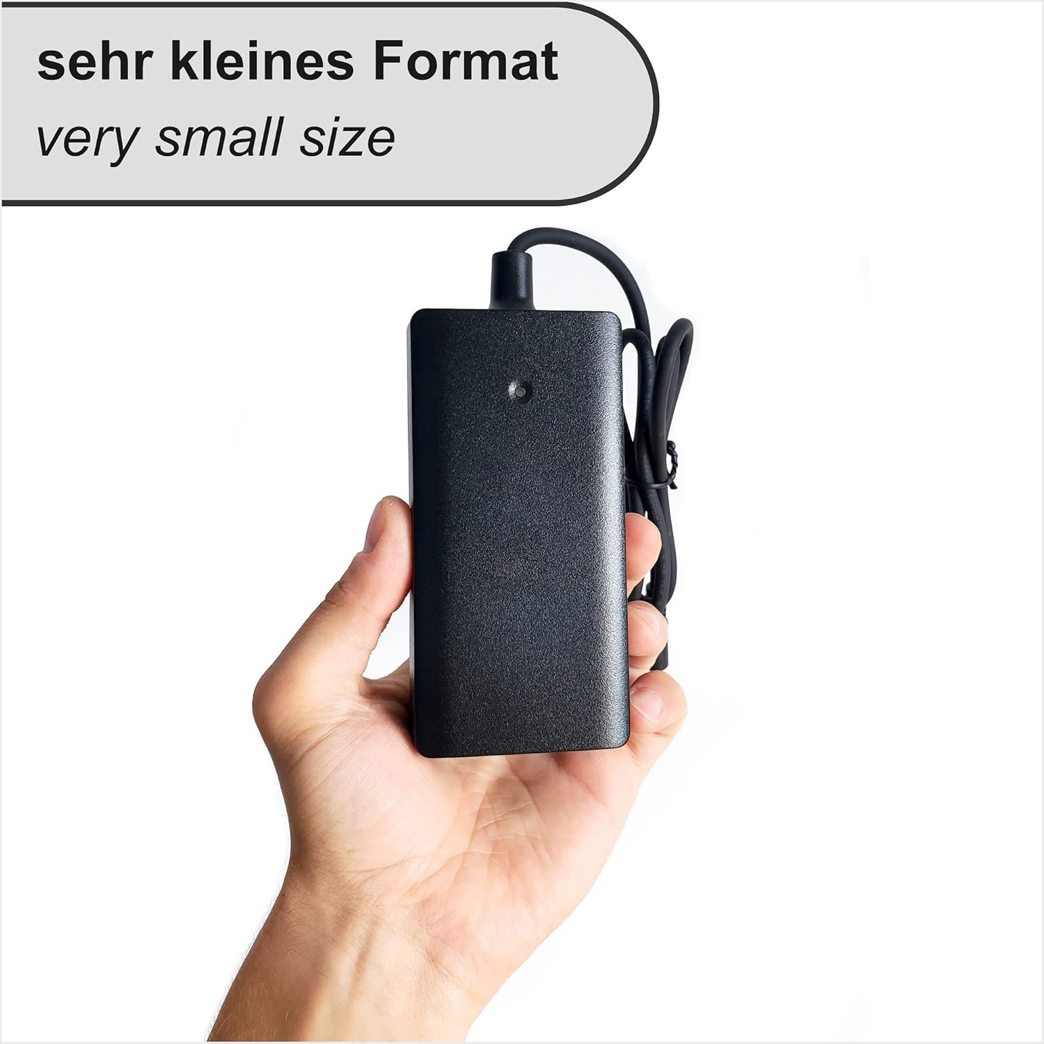 Hand holding the ST charger, illustrating its very small size