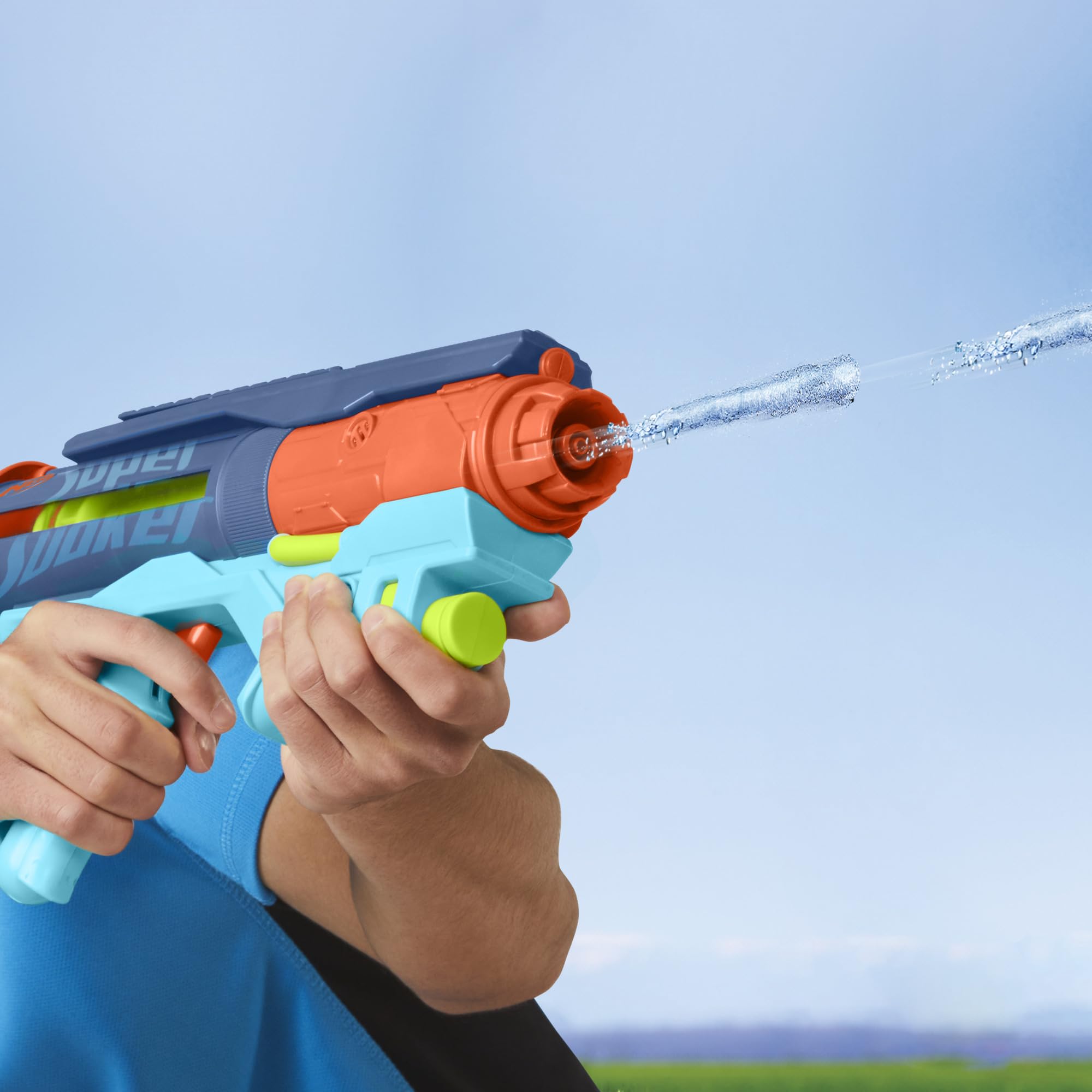 A person holding the Nerf Super Soaker Power Drench Water Blaster, firing a powerful pulse burst of water.