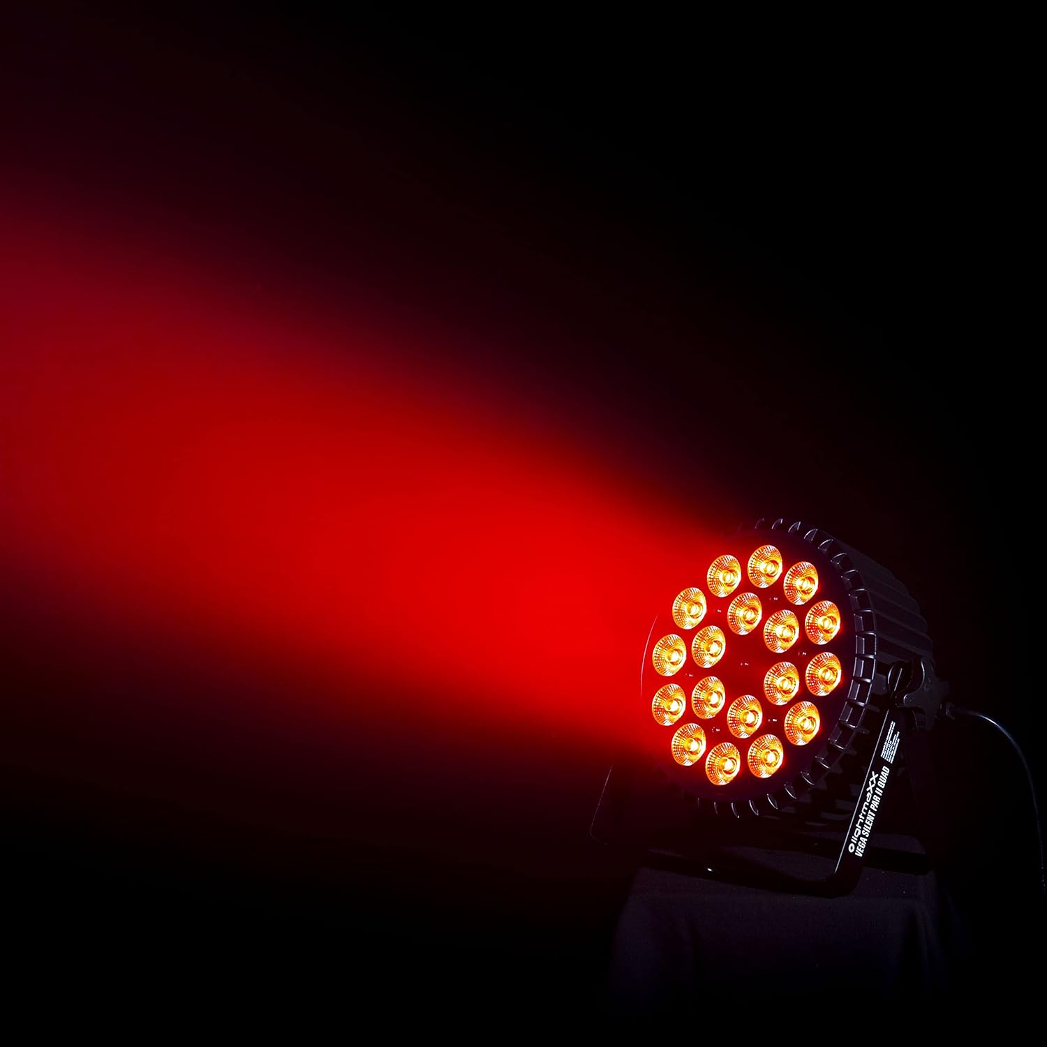 The lightmaXX Vega Silent PAR II Quad projecting a strong red beam of light onto a dark background.