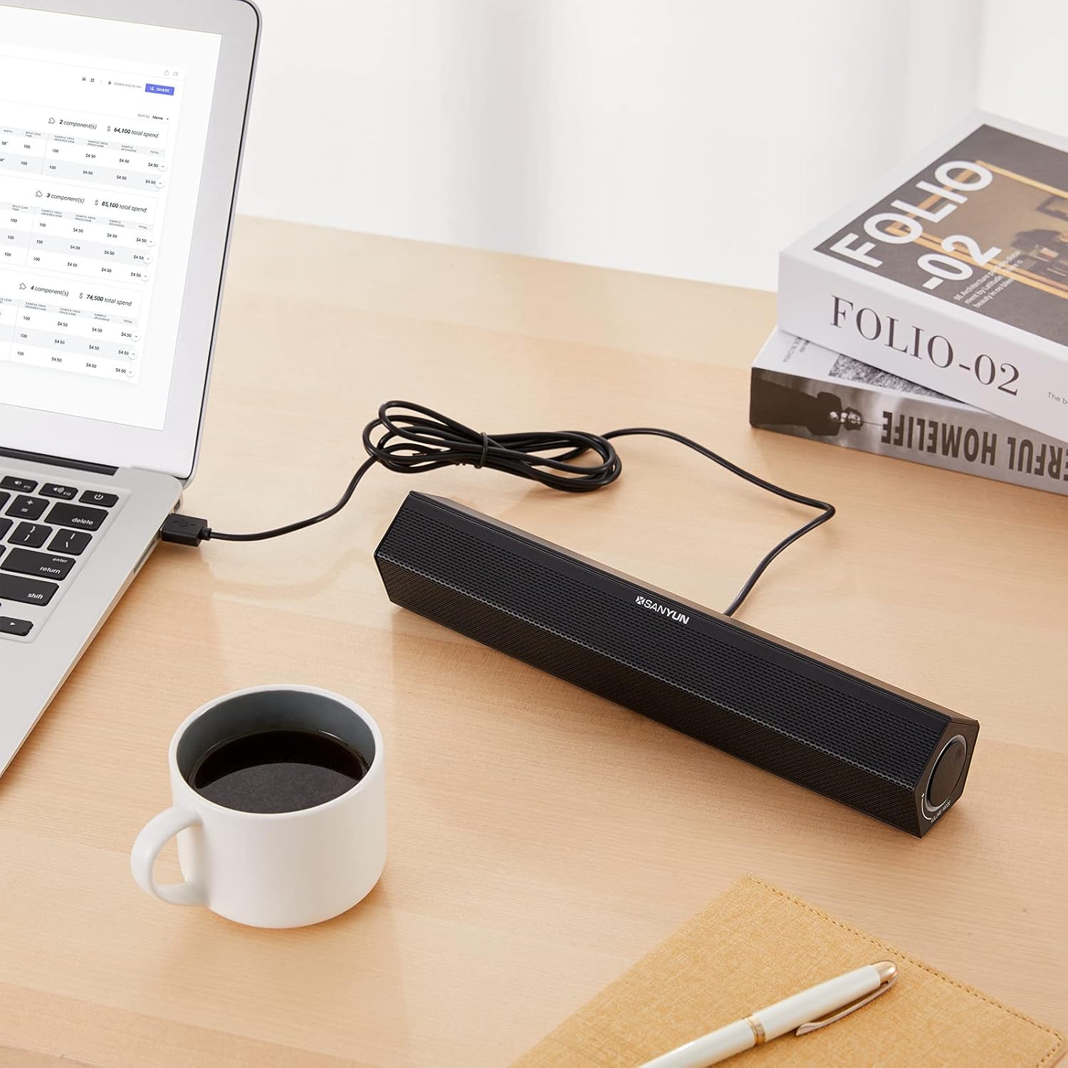 Sanyun SW010 soundbar wirelessly connected to a tablet on a desk