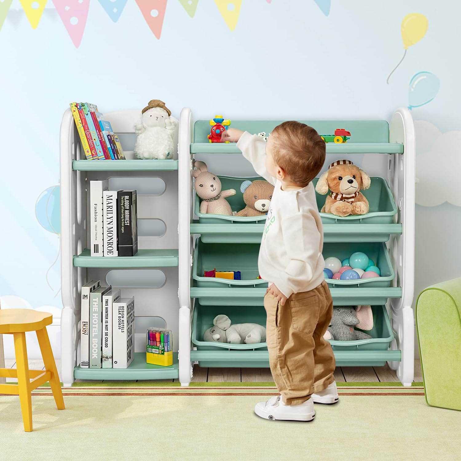 A young child reaching for a toy on the KOTEK 4-Tier Multi-Functional Toy Shelf and Bookshelf, demonstrating child-friendly access.