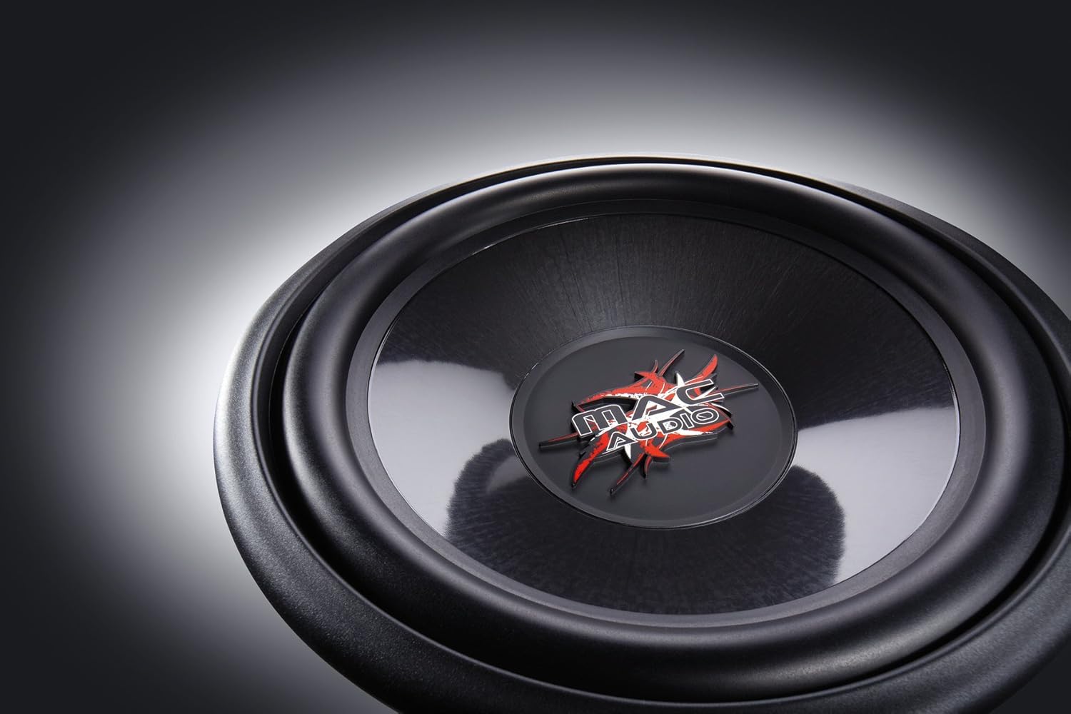 Close-up view of the Mac Audio Ice Cube subwoofer cone, featuring the MAC AUDIO logo in the center.