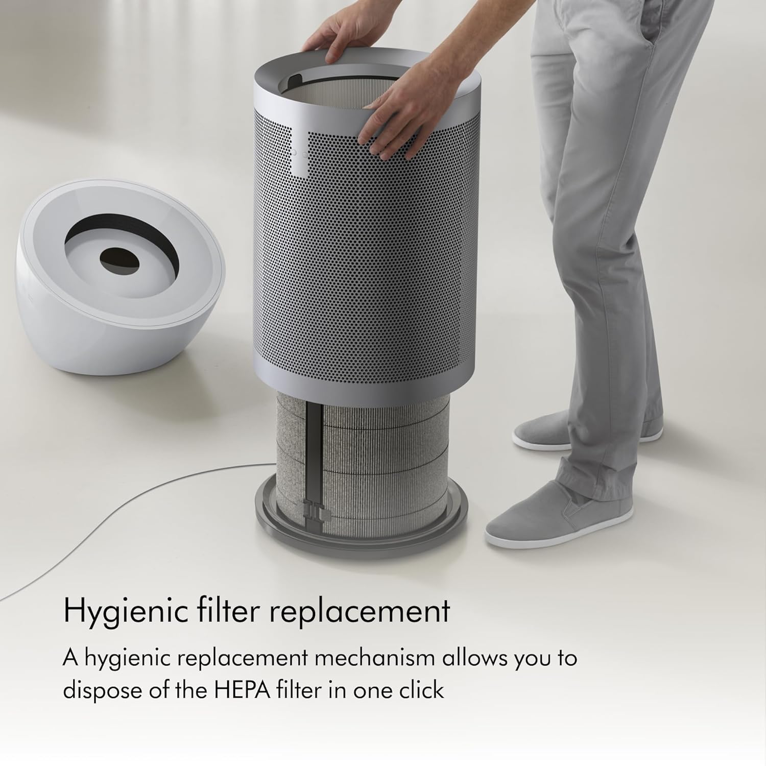A person demonstrating the hygienic filter replacement process for the Dyson HEPA Big+Quiet Formaldehyde BP06, showing the outer casing removed and the filter being lifted out.