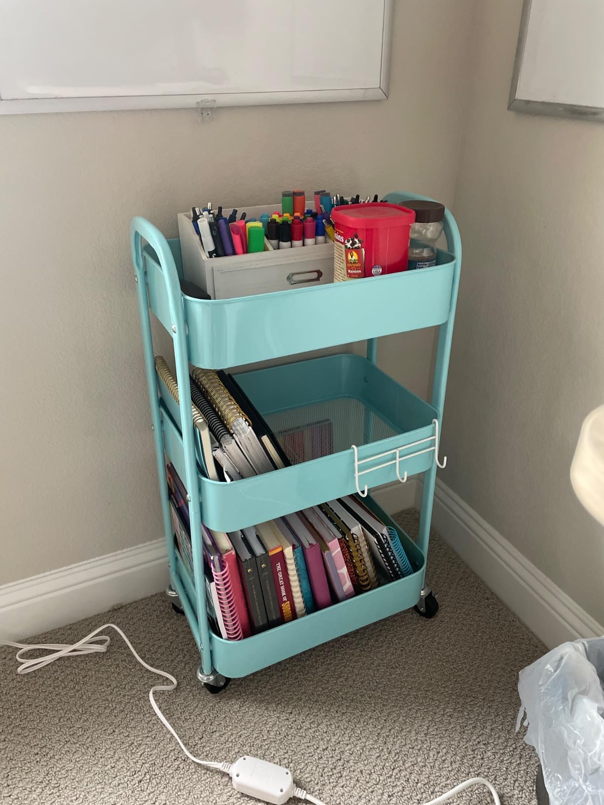 Rolling supply station cart holding classroom teaching supplies