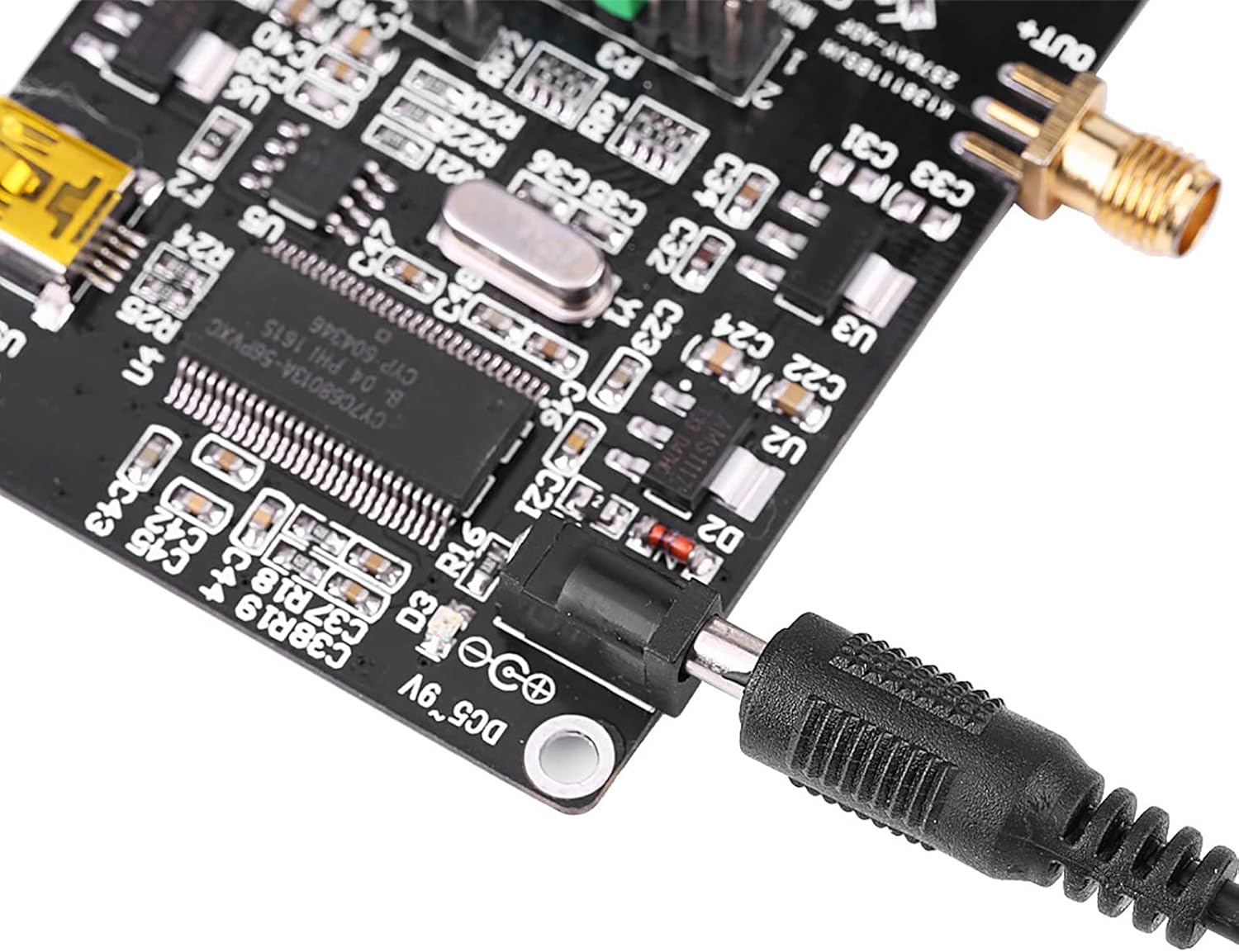 Жакын план view of the DC power input jack on the ADF4351 module with a power cable connected.
