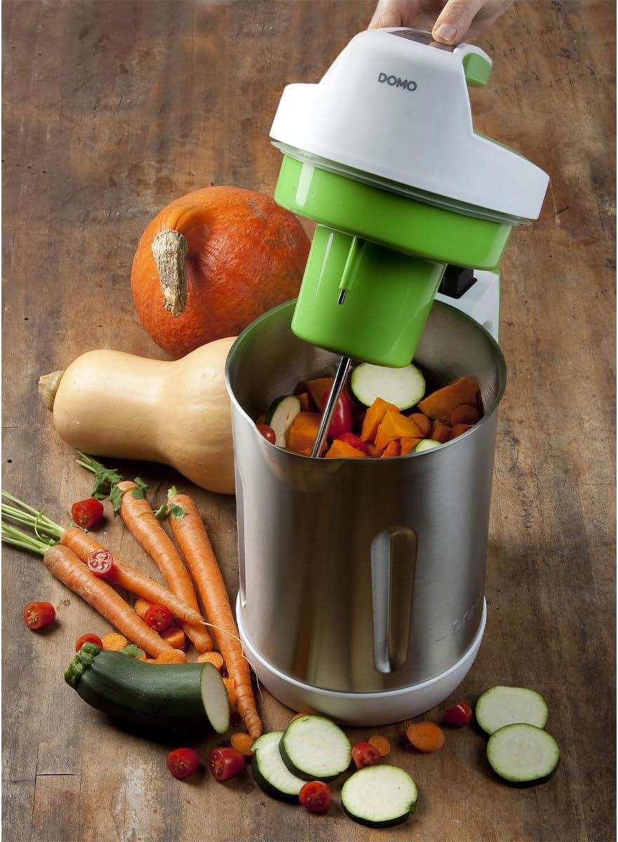 Hand adding chopped vegetables into the DOMO DO705BL Soup Maker.