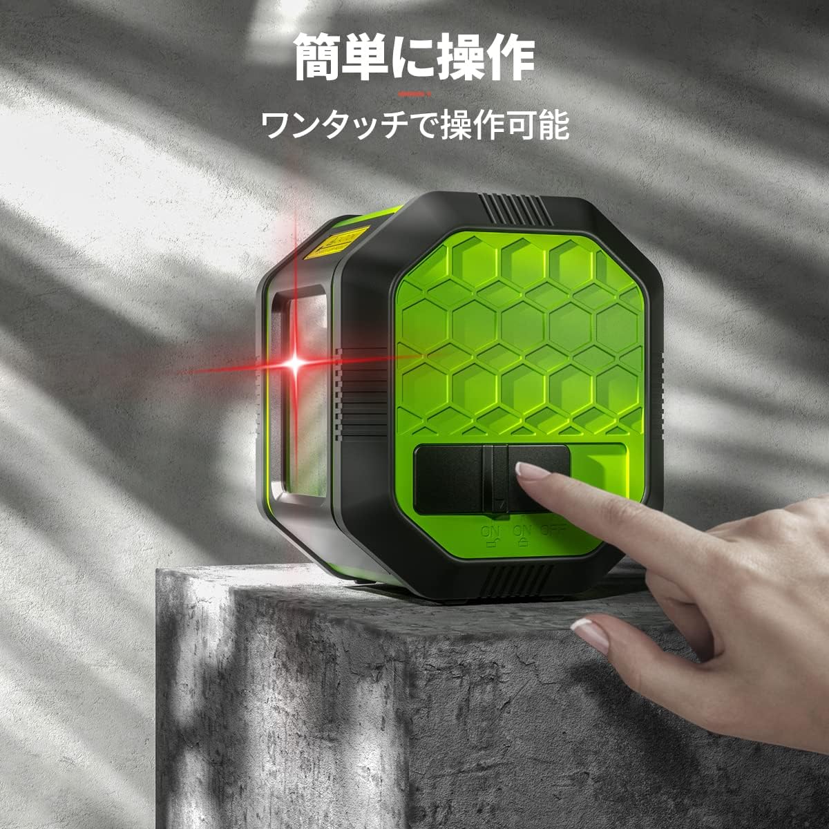 A hand operating the one-touch power switch on the Huepar FC011R Laser Level.