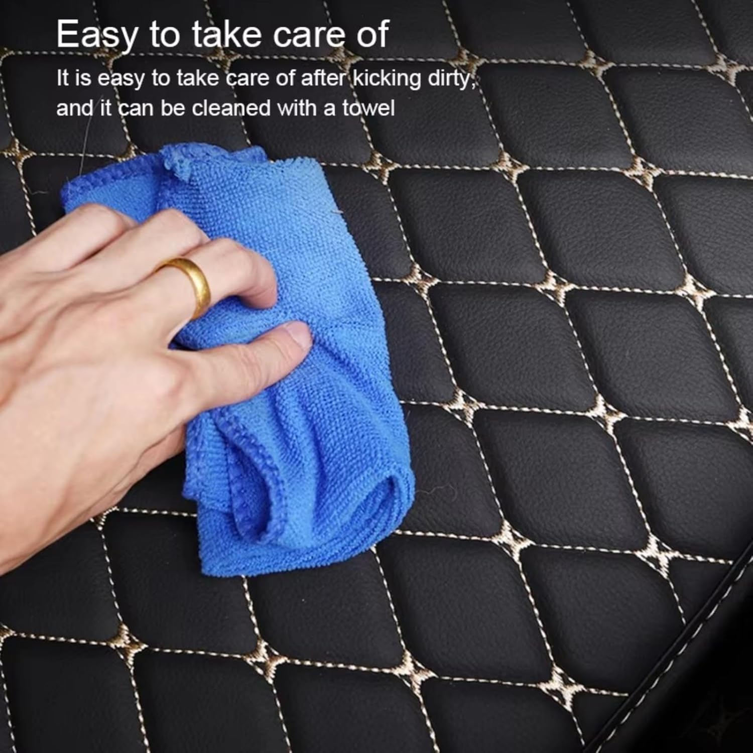 Hand wiping the trunk mat with a towel