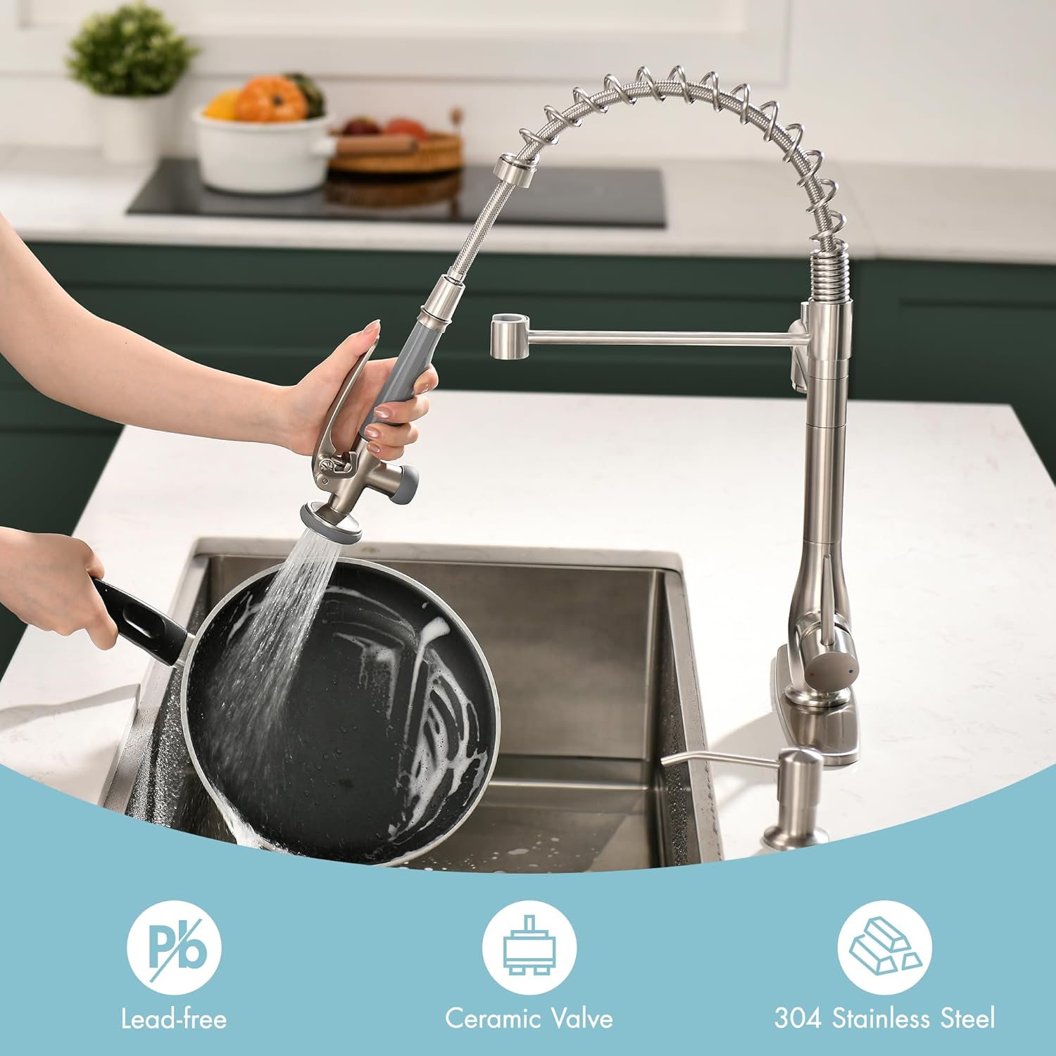 Hand using the pull-down sprayer to rinse a pan in a kitchen sink