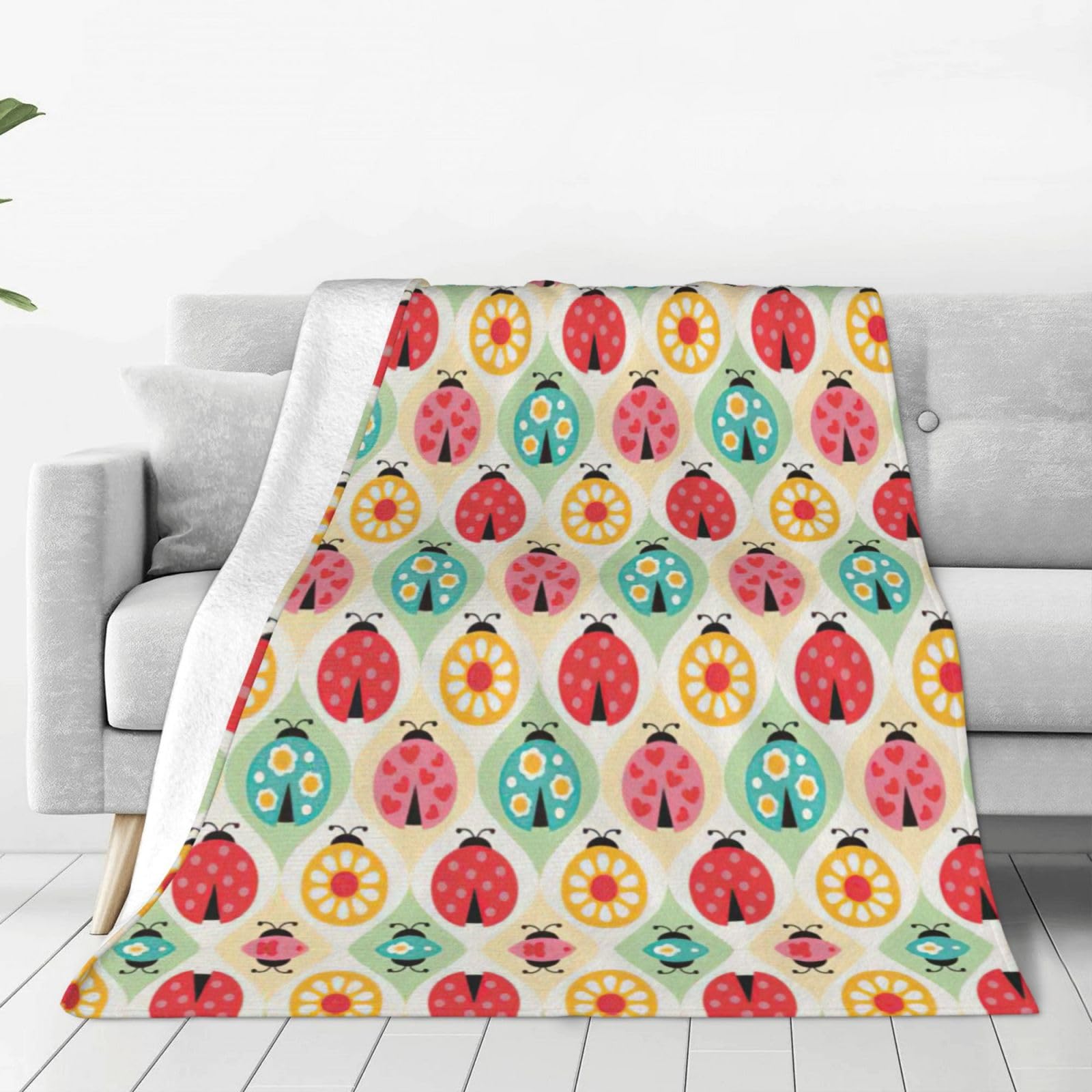Couverture polaire plaid coccinelles pour soirées cocooning au salon