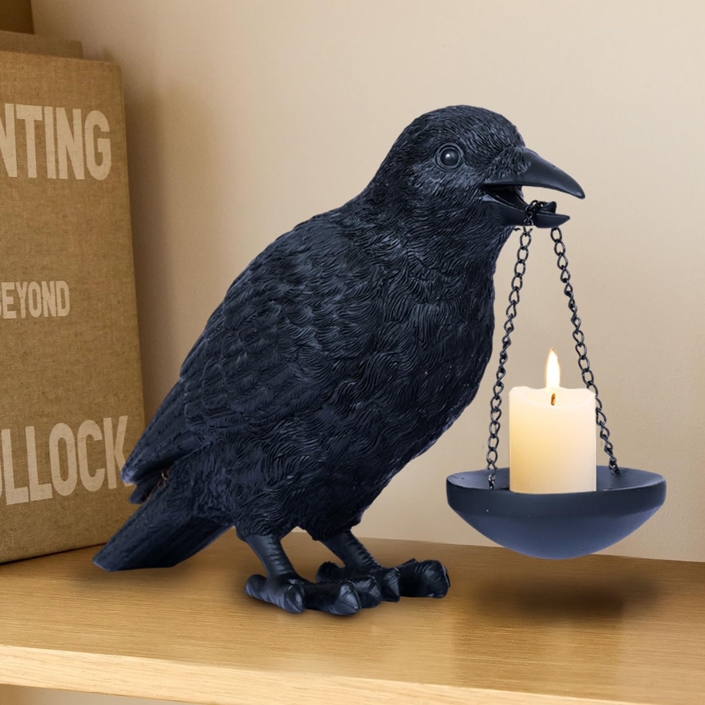 Black resin raven holding a small hanging tealight dish