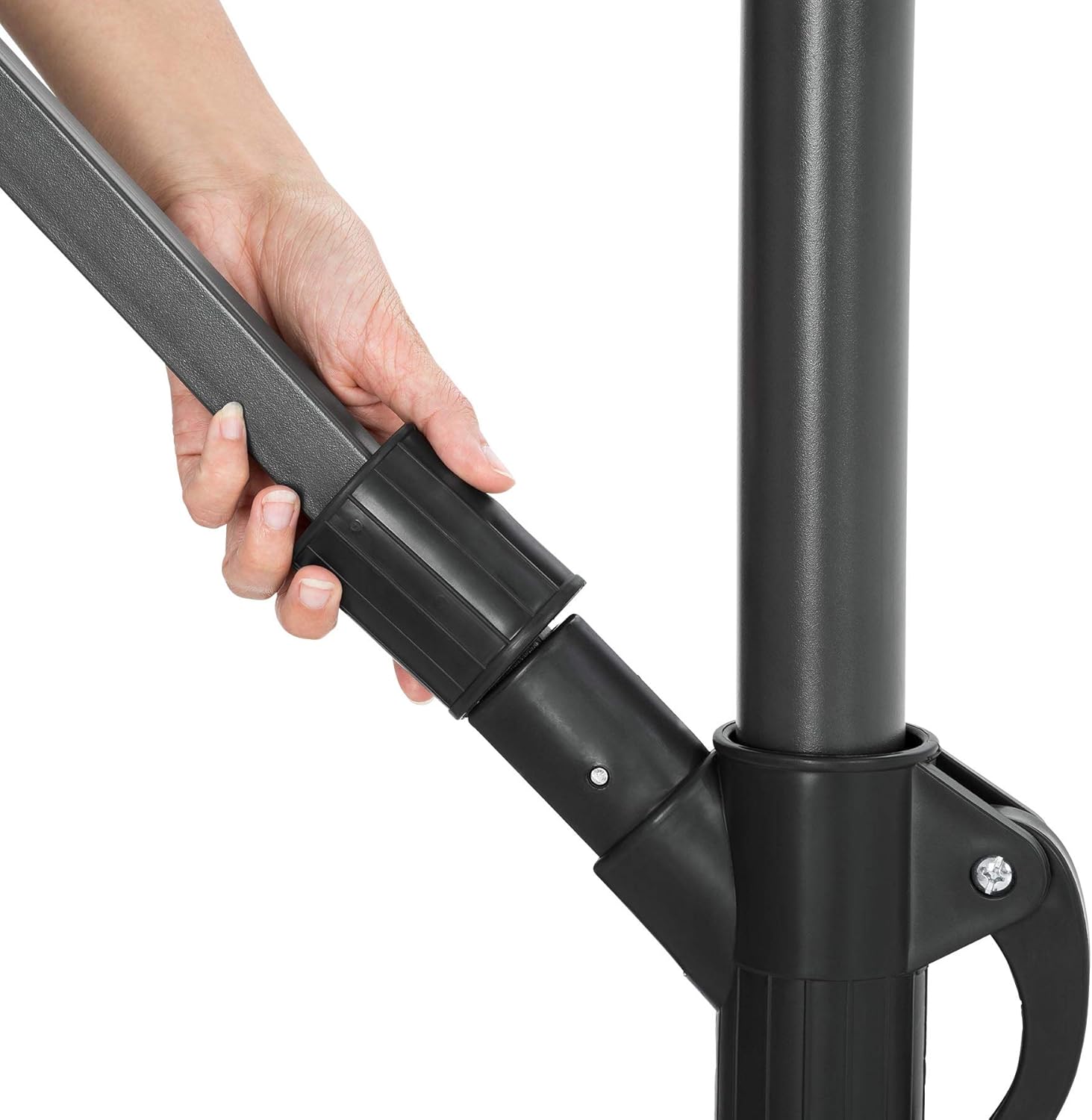 Close-up of a hand adjusting the tilt mechanism on the umbrella pole