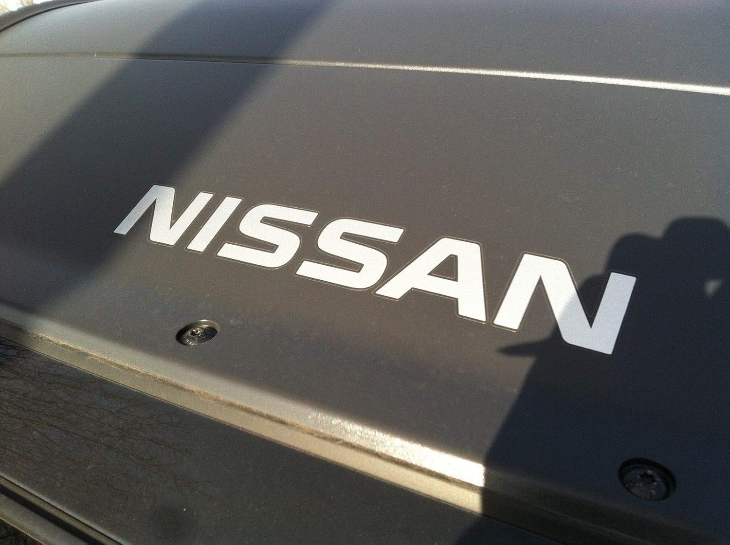 NEW OEM 2005-2014 XTERRA FRONT AIR DAM DECAL/EMBLEM "NISSAN"