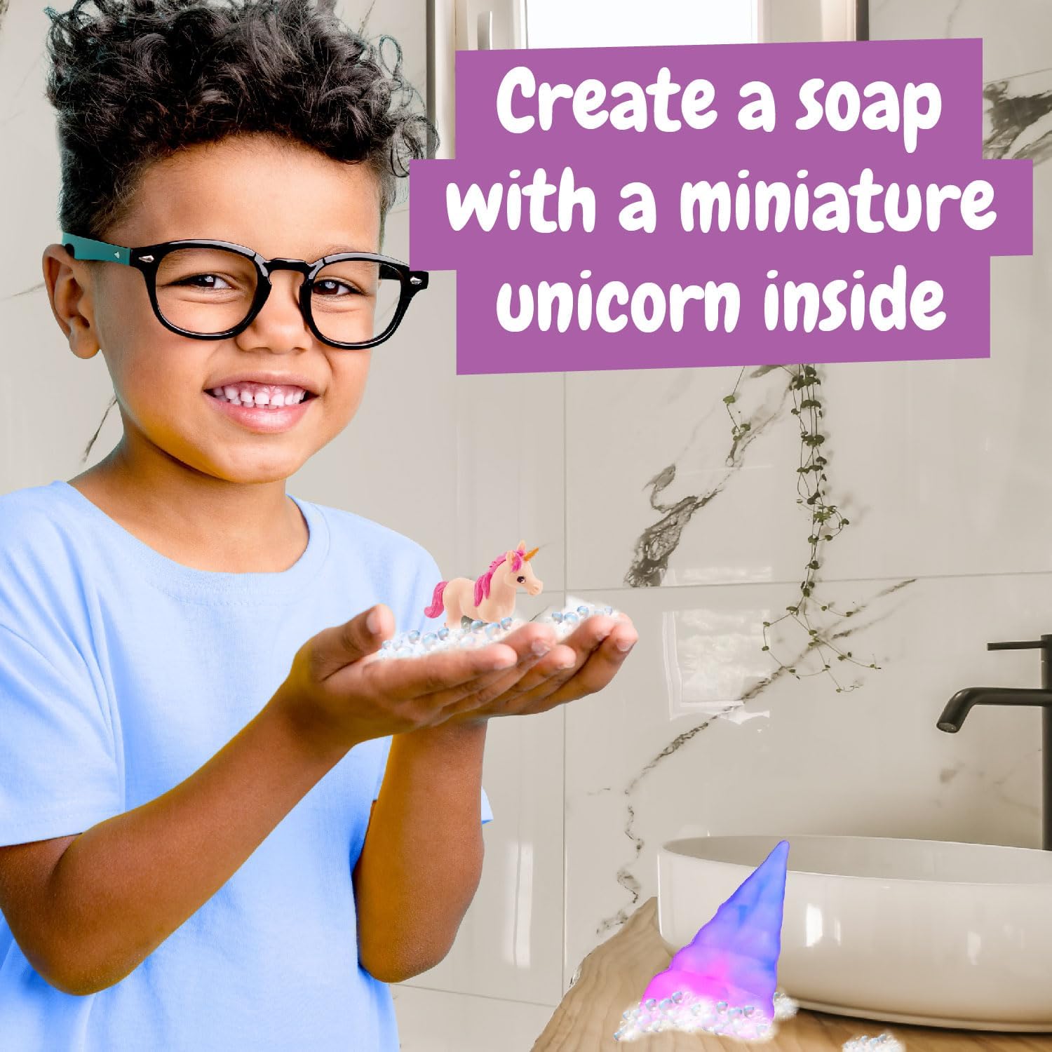 Child holding a finished unicorn soap with a miniature unicorn inside