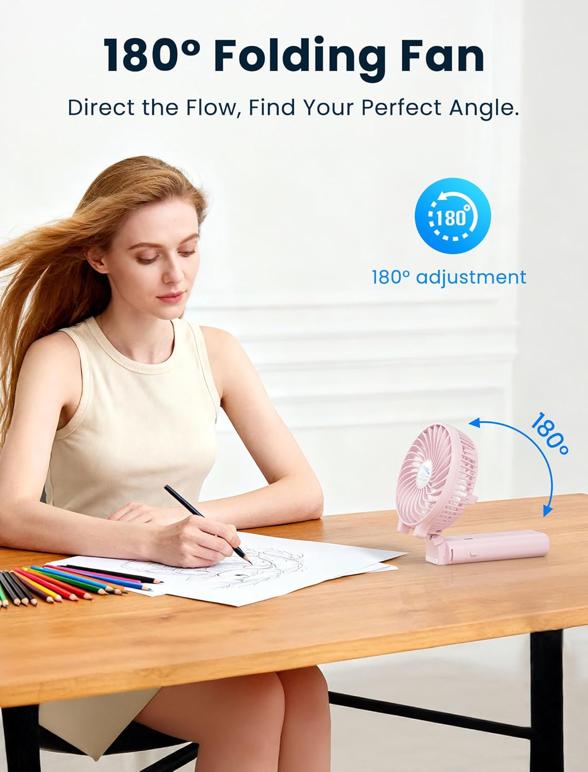 A woman using the HandFan as a desk fan, with the fan head adjusted 180 degrees to direct airflow.